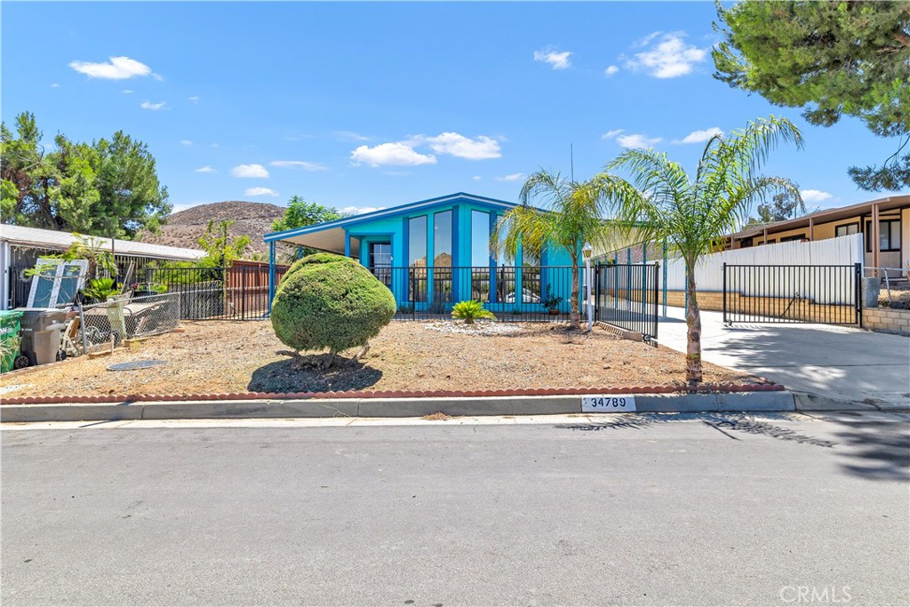 Incredible Gem!!! Natural lights, Amazing Mountain Views in the city of Hemet. This stunning house sits on the permanent foundation with the 433A. Fully financeable with FHA and Conventional Loans. This lovely house features 2 bedrooms, 2 bathrooms with a spacious living room open to dining and kitchen area. A lot of cabinets in the kitchen space. There is a small bar near the kitchen. Vinyl flooring through the house. Laundry room inside house very spacious for the washer and dryer. Primary Bedroom with a big closet to organize your personal items perfectly. Primary Bathroom with double sink, tub and shower. The main bedroom close to the hallway bathroom for your guest's convenience. Back yard with fruit trees to spend time with your family and friends. Huge carport can accommodate at least two vehicles inside the gate. Great porch to enjoy the beautiful summer days with your loved ones that can be used as a rest area. Near shopping Centers, Restaurants and Medical Offices. The property has energy-efficient solar panels system with a purchase agreement that need to be assume by the buyer. No HOA, Low Tax. Don't miss out on this breathtaking property. Definitely A must see set your appointment today!!!