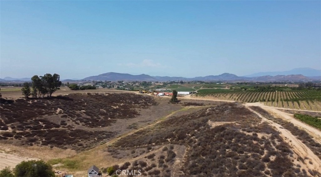 7.67 +/- acre parcel in the heart of Temecula Wine Country. Sloping topography with an elevated area ideal for a view pad site overlooking vineyards and wineries. Zoned Winery District within the Temecula Wine Country Community Plan allowing residential uses, equestrian, agricultural and a Class I Winery. Ideal property that is secluded for privacy but with sloping topography allowing sweeping Wine Country views. Great location close to town but far enough off of Rancho California Rd not to be affected by traffic or noise. Great spot for a private residence plus ADU and/or a small boutique winery operation.