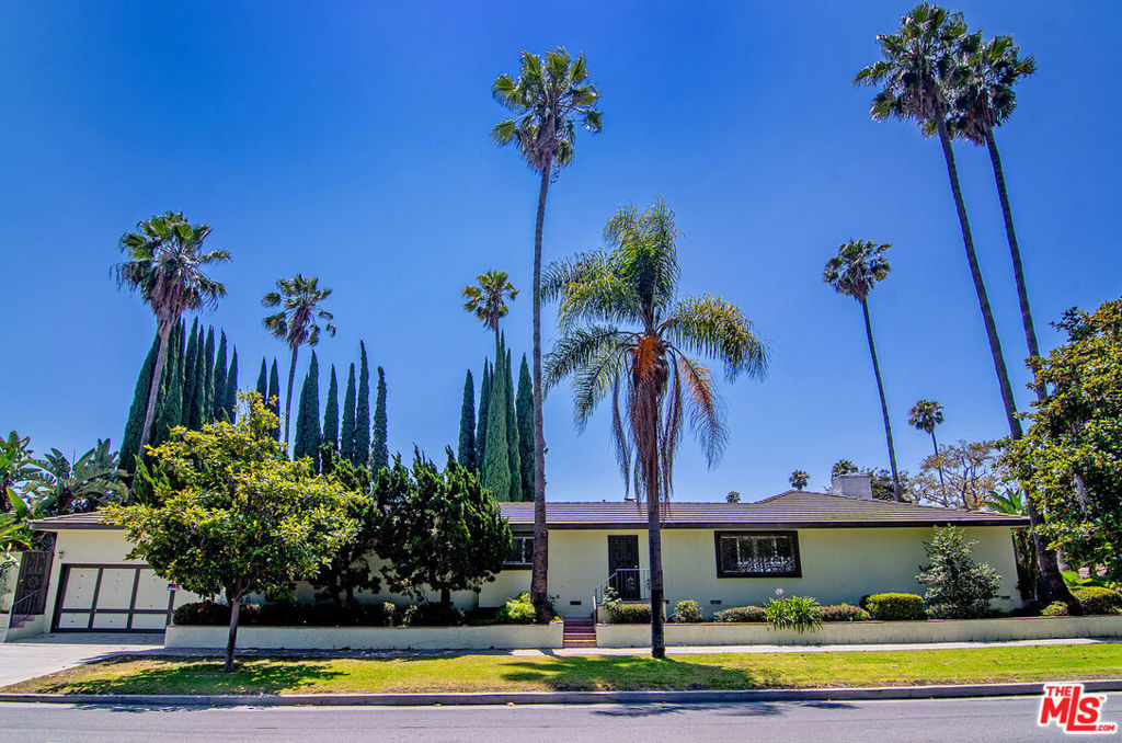 180 N Highland Ave, a private & secure Hancock Park single-family residence with a resort-style outdoor living that's perfect for unwinding or entertaining. The expansive outdoor space features a massive pool surrounded by towering Italian cypress and palm trees, all enclosed by high privacy walls offering peace, security, and a true sense of escape. Inside, the home features a generous living room with a marble-clad fireplace & columns, a formal dining room, and a spacious kitchen with room for culinary delights. A large office adds flexibility for remote work or creative use. All three bedrooms are oversized with excellent closet space. The primary suite includes direct access to the poolside patio ideal for relaxed mornings or evenings under the stars, a grand dressing area with chandeliers and mirrored vanity, a luxurious bathtub w shower + dual vanity. With garage access from Beverly Blvd and surrounded by some of Hancock Park's most iconic architecture, this home offers a rare rental opportunity for those seeking space, privacy, and the best of indoor-outdoor LA living. Minimum 14 month lease.