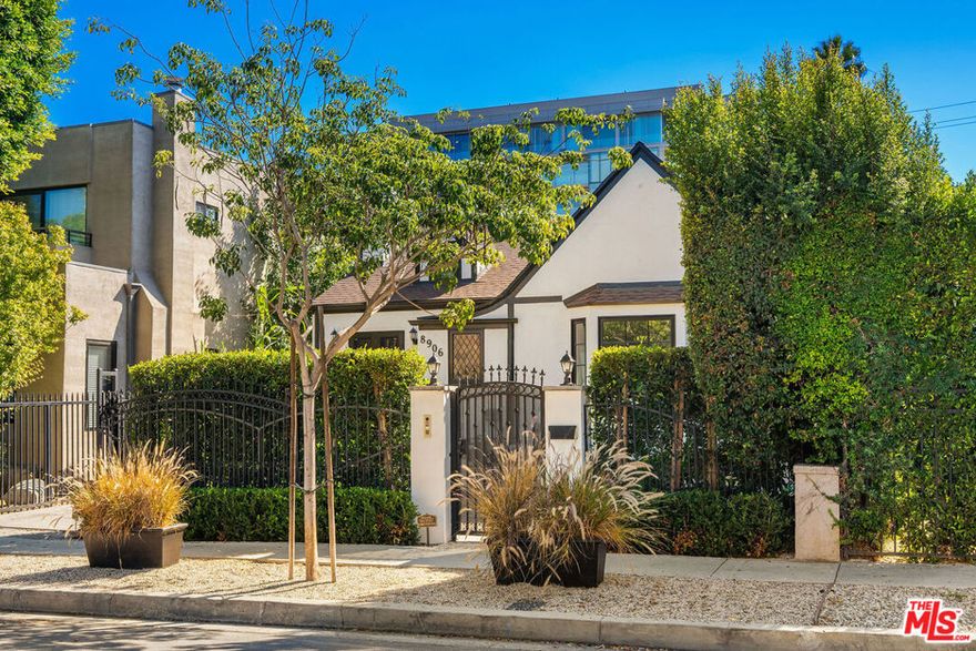 Rebuilt and reimagined to perfection, this rare single-level four bedroom residence embodies timeless elegance with soaring 15-foot ceilings, abundant natural light, and a seamless blend of classic craftsmanship and modern sophistication. Completed in 2023, every detail has been curated with the highest quality finishes and thoughtful design. Step inside to a luminous open floor plan featuring chevron white oak hardwood flooring, multiple skylights, custom millwork, and Forbes & Lomax designer light switches. The chef's kitchen is a true centerpiece with a dramatic 15-foot ceiling,  Jenn-Air professional-grade appliances, dual appliance garages, pot filler, and an oversized island ideal for entertaining. The living room exudes character with original 1920s stained glass, a marble fireplace mantel imported from Europe, and built-in library shelving reaching to the ceiling.  The primary suite offers vaulted ceilings, dual skylights, a gas fireplace, French doors with a Phantom screen system, and a custom walk-in closet. The spa-like primary bath showcases Bardiglio and Carrara marble floors, a clawfoot tub, oversized shower, and an antique door with a diamond-leaded window. Three additional bedrooms each with abundant storage and bespoke details share beautifully appointed bathrooms featuring Calacatta Viola marble and Phylrich fixtures.  Outside, enjoy a serene private oasis with new hardscape and soft scape, diamond-pattern pavers, a motorized driveway gate, and lush privacy hedging.  Additional features include Doorbird entry, EV charging, custom shed with power, and built in speakers throughout.  Perfectly situated mid-block on one of West Hollywood West's most coveted streets, this home offers an unparalleled lifestyle steps from the city's best dining, shopping, and entertainment.