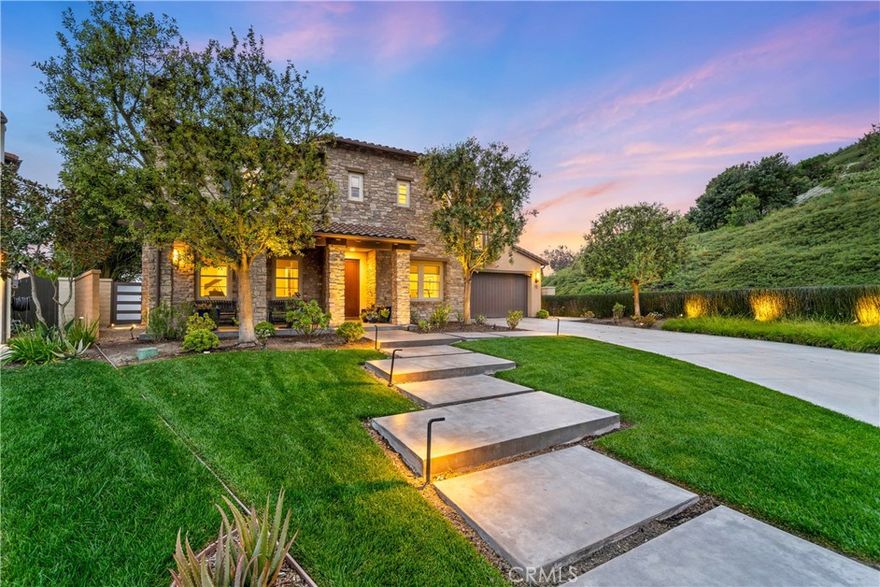 Tucked away at the end of a peaceful cul-de-sac, this stunning 5-bedroom residence offers privacy, space, and panoramic views that are truly second to none. Set on an expansive 11,000 sq ft lot and bordered by serene hillsides and scenic trails, this is more than just a home — it’s your personal sanctuary.



From the moment you arrive, the home’s exceptional curb appeal is undeniable. A beautifully landscaped front yard and extra-long 6-car driveway welcome you in style. Inside, natural light pours through French doors into two elegant front rooms — a formal sitting area with a cozy fireplace and a private office perfect for remote work or quiet reflection.



Rich hardwood floors guide you through a dramatic entryway, where a charming courtyard with its own fireplace and market lights invites effortless indoor-outdoor living. Entertain in the formal dining room, updated with a striking stone accent wall and contemporary lighting — an ideal setting for unforgettable dinner parties.



The open-concept kitchen is a true showpiece, featuring crisp quartz countertops, a walk-in pantry, a butler’s pantry, and a picture-perfect ocean-view window over the sink. Gather with family in the spacious great room, highlighted by custom barn doors, a warm fireplace, and generous natural light.



Step outside to a backyard designed for coastal living — enjoy dining under the covered patio, relax by the outdoor stone fireplace, or watch the sun dip into the Pacific from your private seating area. There's even room to build the pool of your dreams, surrounded by updated landscaping and ambient outdoor lighting.



Upstairs, the expansive owner’s suite offers a luxurious escape with wainscoting details, ocean-view sitting area, two walk-in closets, and a spa-like bath with dual vanities, soaking tub, and elegant white and grey finishes. The private balcony provides breathtaking ocean and sunset views — day and night.



The home also includes a convenient downstairs en suite guest room, three additional upstairs bedrooms, and a spacious loft/media room — perfect for family movie nights or a second living area.



With top-rated Vista Del Mar schools just a short walk away, trails and parks at your doorstep, and shopping, dining, and world-class beaches within minutes, this location is unmatched. Plus, Talega residents enjoy access to resort-style amenities including pools, tennis courts, playgrounds, sports facilities, and a vibrant calendar of community events.