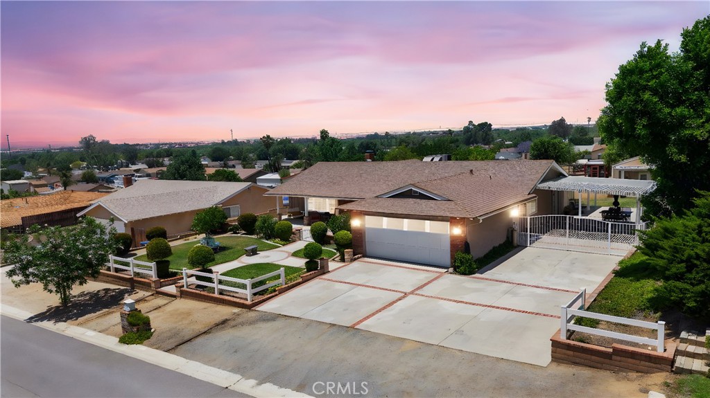 You’ll fall in love with the gorgeous charm of this single-story ranch-style home, perfectly situated on a ½-acre elevated view lot in Norco’s desirable equestrian community. This residence is rich in custom details, with laminate-wood floors, custom view windows, and wood trim throughout — creating an inviting atmosphere that blends comfort and style.
Offering 4 spacious bedrooms (one en-suite) and 2 bathrooms, the home features a large open living room, a cozy open family room with wood burning gas fireplace, custom wood mantle, wall to wall built ins, and a sun-filled day room that perfectly frames both sunrise and sunset views. The expansive kitchen includes custom hutch-style cabinetry, a family-sized layout, and catches a refreshing natural breeze that flows effortlessly through the home.
Step outside and enjoy gated grounds perfect for any and all occasions — from peaceful mornings to large gatherings. Entertain with ease thanks to the gated pool, covered patio, private passage gate, and front courtyard with brick-accented hardscape. There’s also a 2-car attached garage, RV parking, chicken coupe and multiple storage sheds for all your large-lot needs.
The lot includes an extra Bonus Room with French doors overlooking the backyard and can be used as a pool house, studio, or additional living space. The property is zoned for horses and surrounded by Norco’s scenic horse trails, mature trees, and a thriving lemon tree.
Conveniently located near the heart of Norco’s community events and rural charm, this home has it all — space, character, and unbeatable curb appeal.
