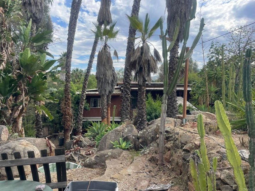 This is your dream fixer in San Pasqual Valley! Massive 1.8 acre property with plenty of room for an ADU or pool. Nearby attractions include Orfila Winery, San Diego Zoo Safari Park, Hungry Hawk Winery, Kit Carson Park, Queen Califia's Magical Circle, & North County Mall bringing Round1 Bowling & Arcade to North County. CASH or construction loan/FHA 203K. Septic/Solar. County Animal Code L. Property to be sold in AS-IS condition and cannot close escrow until Feb 2026. Plenty of time to dream!