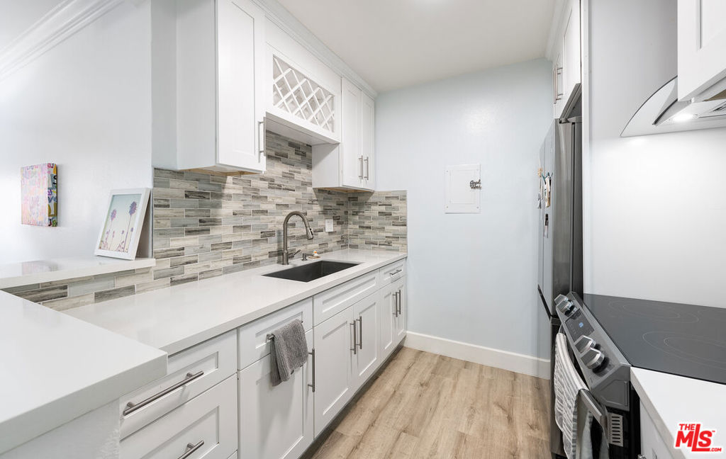 Enjoy resort style living in this one of a kind converted 2 bed 1 bath stunner at the beautiful Cross Creek Village Condo complex. No expense was spared to convert this one bedroom unit into TWO private Bedrooms. This spacious home offers a generously sized living room with exquisite wood floors throughout and updated lighting. Gorgeously renovated kitchen with elegant kitchen cabinets, stainless steel appliances, quarts counter tops, high quality backsplash and modern fixtures. Find your Zen in your very own Private outdoor balcony with all the bells and whistles for your quiet enjoyment. Last but not least, walk into to your tastefully remodeled bathroom with modern fixtures. Enjoy flowing streams, beautifully landscaped grounds, new gym, 2 heated pools, spa, sauna, tennis courts, pickleball courts, basketball courts, a playground, secure parking, bike storage and minutes to beach. You also have a newly updated clubhouse with brand new kitchen, new furniture, pool tables, ping pong, 2 fire places and conference room. 10 min to LAX, Loyola Marymount University and local schools. Your search is over. Welcome home!!! Buyer and buyer's agent to satisfy all buyer investigations. Information deemed reliable, but not guaranteed. Buyer and buyer's agent to verify all information on MLS and other sources.