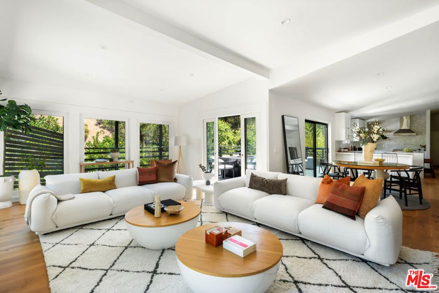 A Private Designer Retreat in the Heart of Studio City.  Tucked behind gates and lush landscaping, this reimagined residence blends effortless California living with curated design. Featuring 3 bedrooms, 3 luxe baths, and a versatile loft ideal for a home office, studio, or guest retreat, every detail has been thoughtfully considered.Inside, wide-plank French oak floors flow through a sunlit open layout. The chef's kitchen stuns with custom cabinetry, brand-new appliances, and refined finishes, while each bathroom has been re-envisioned with a modern, spa-like aesthetic. A stone-wrapped fireplace creates a cozy focal point, enhanced by all-new designer lighting throughout.Step outside to your own tranquil oasiscomplete with new concrete hardscape, a private driveway gate, and an elevated patio perfect for sunset moments. Additional upgrades include a new primary closet system, custom doors, and a tankless water heater, making this home as functional as it is beautiful.A rare blend of style, comfort, and privacywelcome to your elevated escape in Studio City