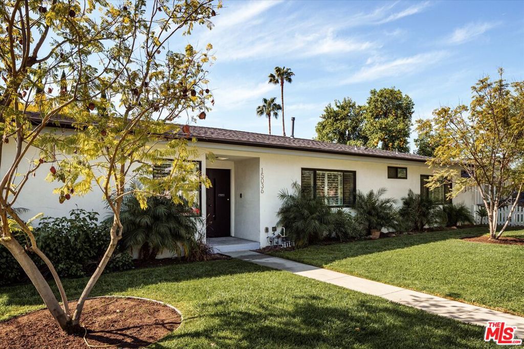Supremely positioned on a corner lot, this fully reimagined home blends contemporary style with a private outdoor retreat in one of Sherman Oaks' most desirable neighborhoods. A meticulously landscaped front yard sets the stage for the bright and inviting interiors, where natural light pours through expansive double-pane windows and sliding glass doors, seamlessly connecting indoor and outdoor living. Mid-toned wood floors flow throughout the thoughtfully designed layout, which includes a formal living room and a spacious family room anchored by a sleek, marble-tiled fireplace. At the heart of the home, the kitchen is a true showpiece, outfitted with a generous center island, stainless steel appliances, stone countertops, a walk-in pantry, and a breakfast nook nestled beside a charming bay window. The adjacent dining area is framed by a built-in bar with custom cabinetry, offering both style and function for entertaining. Four well-appointed bedrooms and three bathrooms provide comfortable accommodations, including a powder bath for guests. The serene primary suite offers direct backyard access, a walk-in closet, and a luxurious ensuite bath. Outside discover a private backyard oasis, where a sparkling kidney-shaped pool, sun-drenched deck, lush lawn, and expansive patio create an ideal setting for alfresco dining and relaxation. Additional highlights include a dedicated laundry room with side-by-side washer and dryer, an EV charger, and an attached two-car garage with direct home access. Situated just minutes from local schools, Westfield Fashion Square, and the vibrant dining and shopping scene along Ventura Blvd, this turn-key Sherman Oaks residence presents the ideal mix of style, comfort, and convenience for effortless California living.