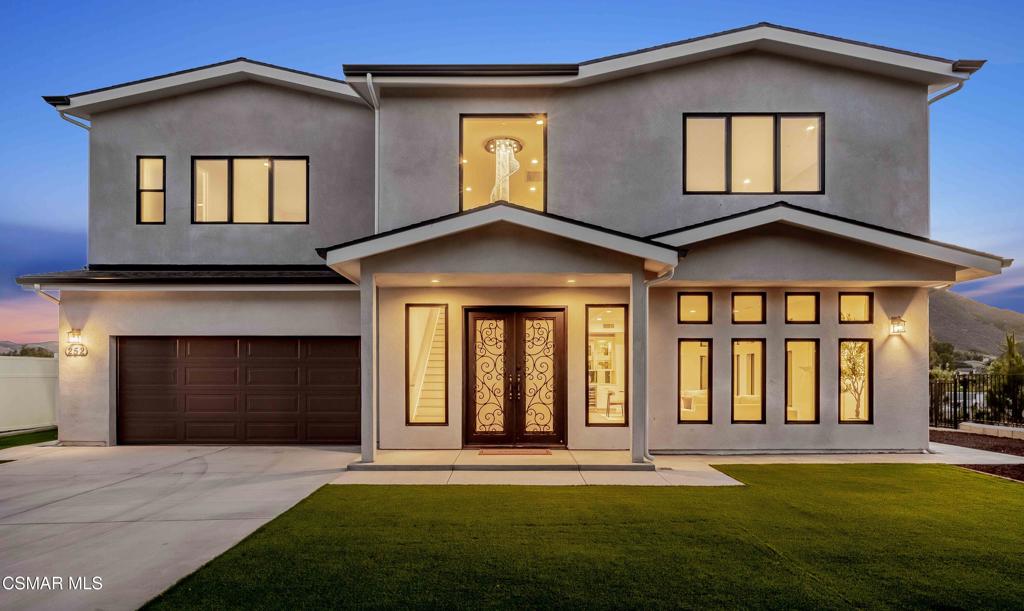 YOU MUST SEE THIS BRAND NEW CONSTRUCTION, built by Mohammad Moalej. Absolutely stunning estate located in West Simi Valley, presents a rare opportunity to own a modern 5-bedroom, 5.5-bath estate on a private gated lot with sweeping views of Mount McCoy and the Sinaloa Golf Course. With 4,500 square feet of living space and situated on a 20,563 square foot lot, this home is designed with a blend of contemporary architecture and thoughtful functionality. A shared private driveway leads to custom iron and glass double doors that open into a light-filled interior with soaring ceilings, engineered wide plank white oak flooring, and Milgard windows and doors throughout. The main level includes an inviting living room with fireplace, built-in bar with wine fridge, and hillside views. The open-concept kitchen features stainless steel KitchenAid appliance suite, quartz countertops, custom cabinetry with glass accents, elegant backsplash and gold accent hardware and pot filler. The oversized walk-in pantry will fit all of your necessities and more! The adjoining family room includes surround sound and large sliding doors that extend the living space onto a rear patio ideal for morning coffee or sunset views. The downstairs also includes a spacious guest bedroom with ensuite bath and custom closet organizers with golf course views, along with a powder room and cozy sitting nook. Upstairs, a central loft area separates the bedrooms for privacy. The expansive primary suite sits at the back of the home, showcasing panoramic views, a private balcony, a luxurious bath with marble flooring, oversized walk-in shower, soaking tub, dual vanities with custom hardware, a walk-in closet with custom organizers which is large enough to accommodate a jewelry/accessory island. Three additional upstairs bedrooms each feature ensuite baths. Two of the guest rooms are Junior primary guest suites, offering walk-in closets with custom organizers, en-suite full bathrooms with porcelain tile finishes, and lovely views. Convenient upstairs laundry room with additional storage. The home includes a 12-panel owned solar system, dual 5-ton HVAC units, tankless water heater, Cat 5/6 wiring, fire sprinklers, a finished two-car garage, new landscaping, and vinyl fencing. Every detail of this home was carefully curated to offer style, comfort, and high-end living in a private West Simi Valley setting. There is nothing else on the market like this fantastic property!