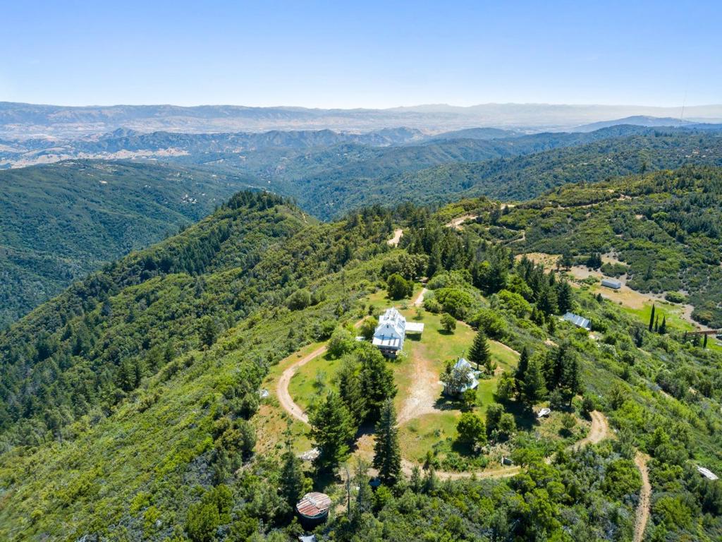 The Value is in the Land....Welcome to the crown jewel of the Santa Cruz Mountains 110 Silverline is a rare, ridge-top property boasting, uninterrupted 360 degree views that stretch from the surfline of the Monterey Bay from Lover's Point, Pacific Grove to Steamers Lane, Santa Cruz and continues all the way over Gilroy and Morgan Hill. Set above the iconic Demolition Forest of The Forest of Nisene Marks and near the Nibbs Knob Waterfall Trail in Uvas Canyon County Park, this site offers a once-in-a-generation opportunity to own a commanding slice of Californias Central Coast wild beauty all close to the Silicon Valley. Although the existing 4,491 sq ft home with 5 bedrooms and 4 baths must be removed per Santa Cruz County, the value lies in the land. Envision a custom retreat, eco-estate, or off-grid haven with world-class exposure and unmatched topography for building your dream compound. Enjoy life at elevation where sunrises and sunsets paint the horizon, where stars shine unfiltered by city lights, and where the only noise is wind in the trees and the call of hawks soaring overhead. Hike and mountain bike through nearby redwood forests, explore secret waterfalls, or simply unwind with panoramic views. Opportunity to also buy APN 106-011-63 and 64.