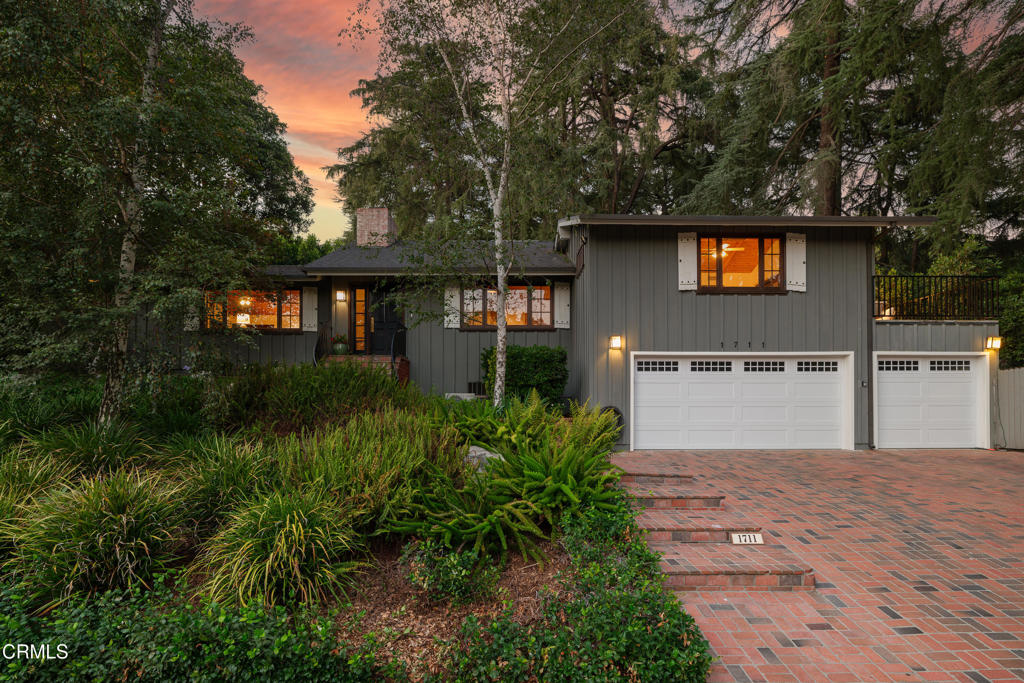 Tucked beneath a canopy of majestic Deodar cedar trees, this exceptional residence rests on a corner lot in the foothills of La Canada. Surrounded by lush, manicured landscaping, the home offers a rare combination of privacy, tranquility & luxury living, a true retreat minutes from city life. Once inside, be welcomed by soaring vaulted ceilings, beautifully wood-beamed & wood-planked, with natural light streaming through clerestory windows & skylights. The expansive living room exudes warmth with a striking brick fireplace & dual sliding glass doors opening to the serene backyard. The chef's kitchen is both stylish & functional, showcasing a brick-topped island bar with stone counters, a Viking Professional 6-burner range & double oven, a Viking hood, a Sub-Zero French door refrigerator, a walk-in pantry & abundant cabinetry. A charming breakfast nook & built-in desk offer space for both dining & daily life, while French doors open to a formal dining room with vaulted ceilings & a custom rustic bell chandelier. The primary suite is a true sanctuary, featuring vaulted wood-beamed ceilings, a built-in wall with cabinetry & lighting, a walk-in closet & sliding doors leading to a private balcony. Its spa-like ensuite impresses with a jetted soaking tub, oversized glass shower with rain head & bench seating, dual-sink quartz vanity & a private water closet. An additional guest bedroom can be found within this wing of the home with an ensuite bathroom featuring a vessel pedestal sink & a shower & tub combination. Completing this area of the home is a stylish guest 1/2 bath with a hammered brass vessel sink. The family room, ideal for entertaining, features custom built-ins & sliding doors that seamlessly connect to the outdoor living spaces. Outside, a sparkling pool is framed by multiple patios, garden paths & secluded seating areas, creating the perfect backdrop for both gatherings & quiet moments. Passing through the family room, you will find the two remaining bedrooms, both of comparable size, the laundry room & a pool-access bath with dual-sink vanities & a glass-enclosed shower. Additional highlights include an air-conditioned bonus space perfect for a gym or home office, abundant storage, a flat gated driveway on the side of the home & a multi-zone HVAC. With its inspired design, luxury finishes & idyllic setting in one of Southern California's most desirable communities, this home offers the best of refined mountain living with unmatched convenience.