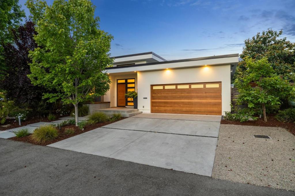 Located in one of Menlo Park's most desirable neighborhoods, this stunning 5-bedroom, 4.5-bath modern residence blends sophistication, comfort and seamless indoor-outdoor living - all on a single level. Designed for both elevated entertaining and everyday ease, the home features soaring ceilings, refined architectural details and expansive, light-filled spaces. At the heart of the home is an impressive kitchen-family great room with a large center island, rich wood cabinetry, sleek slab countertops and stainless appliances. A dual-sided gas fireplace anchors the adjoining family room, while a folding wall of glass opens to the expansive outdoor retreat. The dining area with built-in cabinetry and wine refrigerator enhances the home's entertaining appeal, while a tucked-away office alcove provides convenience. The private bedroom wing includes a luxurious primary suite with spa-like bath, soaking tub, dual shower heads and a large walk-in closet. Three additional bedrooms share a central lounge, including a junior suite and a Jack-and-Jill bath. The separate 5th bedroom with en suite bath is ideal for guests. Outside, enjoy a generous deck, sparkling pool, turf lawn, fireplace, raised garden beds and playhouse. Close to downtown, Stanford, Sand Hill Rd. and top Menlo Park schools.