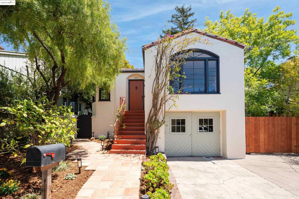 1067 Neilson sits on a tranquil, tree-lined street in one of Albany’s finest locations. With a balance of residential homes and local amenities, you're just a short stroll to Solano Ave and Hopkins Corridor cafés and shops. The main home includes two bedrooms and one bathroom, with original hardwood floors, generous natural light through large windows, and a layout that feels both functional and welcoming. Complete with a breakfast nook and a formal dining room, each space is thoughtfully arranged, offering flexibility for daily life. Beneath it all, a spacious basement mirrors the home’s full footprint, offering room to tinker, store belongings, or perhaps grow the home’s possibilities in the future.* Tucked into the large landscaped backyard is a detached ADU* with its own bathroom**. The secluded and adaptable space is well-suited for guests, a studio, or a quiet home office. With mature trees, multiple seating areas, and large planters, the garden is your sanctuary. Additionally, a private gate in the backyard makes for convenient access to Jewel’s Terrace Park. Out front, the home boasts a garden and a wide driveway for extra off-street parking. Bath count differs from record. Buyer to investigate. 2br/1ba home with studio ADU. Marketed square footage combines house and ADU