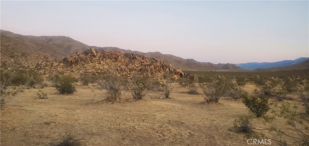 5 Acres in rural area of Apple Valley! Several newer homes in the area. Come build your new custom home on a corner lot fronting Esaws Ave and Laguna Seca Dr. Looking north you see large rocky landscape in this highly desired area. Beautiful desert and mountain views! If more land is desired the 5 acres next door is also available. In this area you would need to put in a well for water, septic system and use a propane tank. Owner is willing to carry with half down! APN: 0436-171-23-0000 This property does not have an address assigned. "5 Acres Esaws Avenue" is for listing purposes only.