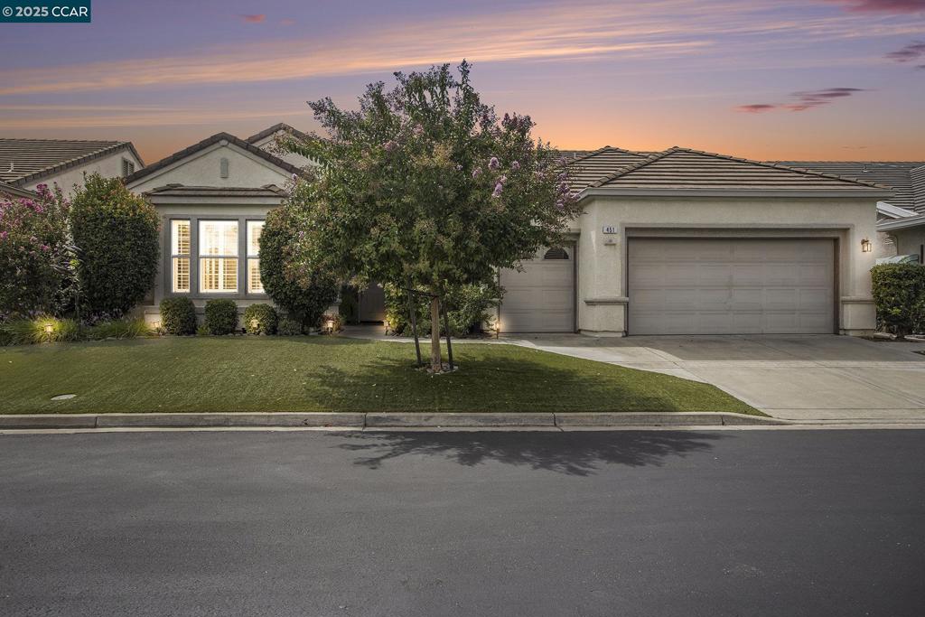 Step inside this beautifully remodeled home with soaring ceilings, custom moldings, recessed lights and hardwood floors. At the heart of the home you will find an expansive great room, equipped with gourmet kitchen and an oversized quartz island. A fabulous set up to host large gatherings. Homeowners can retreat to their spacious primary suite. There is also a guest suite. All bathrooms have been remodeled and provide homeowners and guests with a spa-like feel. Work from home in the large office. This space can also be used as a separate craft room or third bedroom. Enjoy alfresco meals on the covered back patio. Dual paned windows, custom shutters and honeycomb blinds help with the home's energy efficiency and comfort. A 3-bay garage provides extra storage. Environmentally friendly artificial turf delivers lower water usage at the front and back yard. Vibrant 55+ community with many healthy lifestyle amenities like pool, tennis, gym, pickleball and more. Central location close to shops, restaurants and freeway access. 30 minutes to Livermore or Walnut Creek.