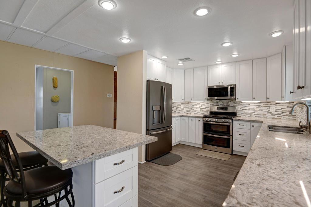 Welcome to this remodeled getaway with the privacy of a corner lot! This spacious 2 bedroom + den, 2 bath home boasts a remodeled chef's kitchen, a living room, a large dining room, a sitting area, a wet bar, and large laundry room with office alcove and abundant storage. The pitched ceilings further expands this sizeable space. Enjoy the golf course and expansive mountain views with your guests. There is even room for a golf cart and additional storage. Have a lifestyle full of amenities and activities at Hidden Springs Country Club, a well-maintained 55+ gated community on a golf course. There are 2 dog parks, pool, 2 spas, sauna, gym, library, billiards, tennis court, 2 pickle ball courts, shuffleboard and group activities. Total space rent is $734.35/month for the lease + $8/month for improvements. Buyer(s) must be approved by Hidden Springs Country Club/Treehouse Communities and have income of 3x space rent or more. Primary and secondary homes only, no rentals. Sellers are seeking a cash offer.