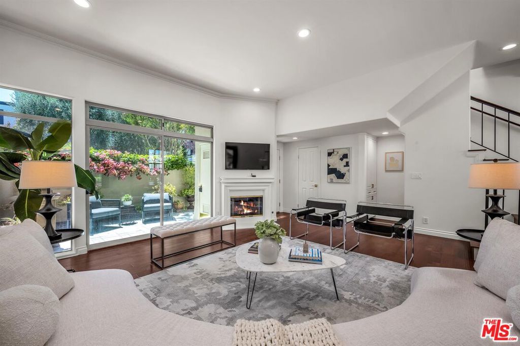 This is not your average condo. If you are seeking turn-key perfection, look no further than this pristine designer-done 2 story townhouse. Located on a lushly landscaped and quiet block south of the boulevard, you're only steps away from fine and local favorite eateries, as well as gourmet markets. No dark condo hallways here. Your own private gated street level entrance leads into a spectacular living room with gloriously high ceilings, brand new engineered hardwood floors (which are throughout the unit), gas fireplace and sliding glass doors out to a lovely blooming patio. Step up to your formal dining room with a view of the huge walled rear patio and into a newly refurbished kitchen featuring Canyon Lake tile backsplash (by Studio McGee for Anne Sacks), kitchen faucet (from the Studio McGee Collection at Kohler), and all new hardware and appliances. Upstairs you'll find a serene primary bedroom with vaulted pitched beam ceilings, balcony, en-suite bath and walk-in closet. Two other spacious bedrooms share a full hallway bath, and all bedroom floors are covered in a luscious creamy carpet into which you are invited to sink your toes. Building amenities include two side by side parking spaces in a gated garage, sparkling pool (heated in season), earthquake insurance.