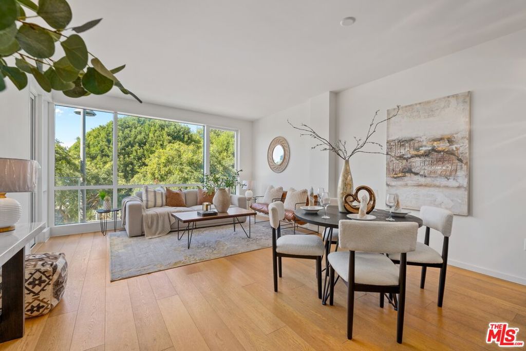 This beautifully designed one-bedroom, two-bath home features an open floor plan with floor-to-ceiling windows framing serene views of Tongva Park and filling the space with natural light. The chef's kitchen showcases Thermador stainless steel appliances, Sea Pearl quartzite countertops, and custom oak cabinetry, seamlessly connecting to the spacious living and dining areas that open to a private park-facing terrace.The primary suite offers peaceful park views, ocean breezes, a walk-in closet, and a spa-inspired bathroom with dual vanities, soaking tub, and glass-enclosed shower. Additional highlights include hardwood floors throughout, in-unit washer and dryer, two side-by-side parking spaces, and a private storage unit.Residents enjoy five-star amenities including a 24-hour concierge, state-of-the-art fitness center, and exclusive access to the Skybridge Lounge with a full kitchen, fireplace, BBQ, and sweeping ocean views. Perfectly located moments from Santa Monica Beach, The Pier, 3rd Street Promenade, and world-class dining, this residence defines modern coastal living at its finest.