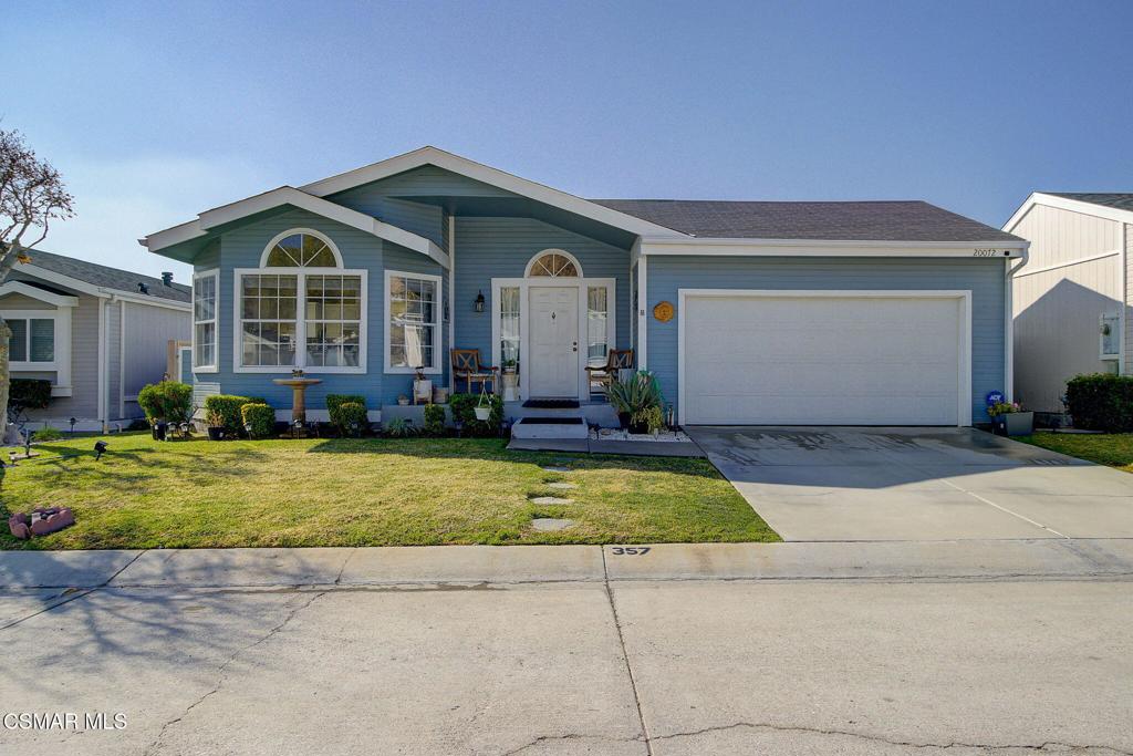 Nestled in a secure gated community, this charming 3-bedroom, 2-bathroom manufactured home offers 1,482 sq. ft. of modern comfort and style, complete with an attached 2-car garage.The inviting living room boasts vaulted ceilings and a cozy gas fireplace with a hearth, perfect for extra seating while entertaining or simply warming up on chilly evenings. Wood laminate flooring flows seamlessly throughout the main living areas, enhancing the home's contemporary feel. The beautifully designed kitchen is a chef's delight, featuring sleek countertops, updated appliances and ample cabinet space. The breakfast bar counter is great for casual meals, entertaining guests, or savoring your morning coffee.Each bedroom is equipped with ceiling fans for added comfort and new blinds for enhanced privacy and light control. The primary bedroom features a sliding door to the backyard, offering easy outdoor access and plenty of natural light, along with a vaulted ceiling that enhances the spacious and airy feel of the room. The spacious en-suite bathroom offers a spa-like retreat with a separate step-in shower, a luxurious soaking tub, a double vanity, and elegant tiled flooring. Natural light pours in through well-placed windows, creating a bright and airy ambiance. A brand new toilet was just installed in the second bathroom.A dedicated laundry room provides additional storage and space for a side-by-side washer and dryer.Step outside to your private, fenced backyard, an ideal setting for entertaining! Serene hillside views of the local mountains for a picturesque and peaceful backdrop, perfect for enjoying stunning sunsets and tranquil mornings.Located in a highly desirable gated community with 24-hour security, residents enjoy access to an array of amenities, including two pools, a spa, two sport courts, two playgrounds, a clubhouse, and RV storage. The home is also conveniently situated near parks, walking and biking trails, shopping, schools, and entertainment, with easy access to freeways and the Metro-Link.With access to all community amenities, this home blends comfort, convenience, and affordability. Don't miss out! Schedule your private showing today!