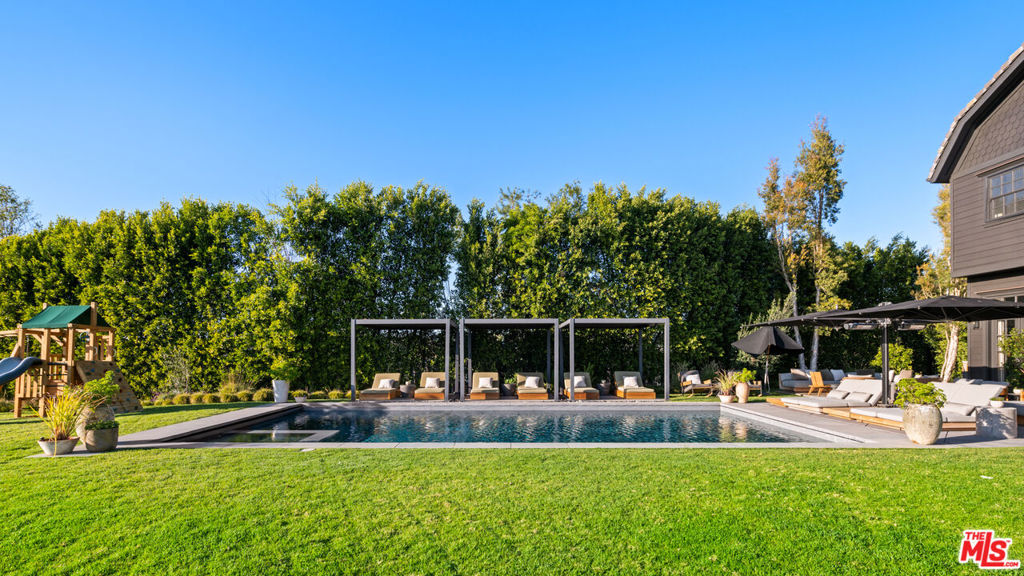 Stunning estate located in an ultra exclusive gated enclave. Situated behind gates on 1.85 acres overlooking incredible canyon and ocean views. The home was completely remodeled by Tommy & Kathy Clements who implemented a perfect blend of natural and warm organic materials, reclaimed woods and rare marbles/stone throughout. There's a beautiful 2 story entry with large living room, spectacular family room, gourmet kitchen with eat-in breakfast room, formal dining, office/library. Upstairs primary suite with sitting room and fireplace with separate dressing areas/walk-in closets and spectacular bath. Separate gym and world class theatre. Sprawling grounds include a huge grassy lawn, large swimmers pool, cabana & bbq.