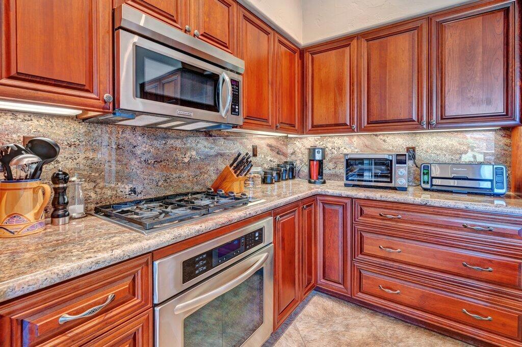 Step into wide-open elegance with this beautifully upgraded Willow floor plan at the sought-after Palm Valley Country Club. Thoughtfully remodeled with walls removed to create a spacious, seamless flow, this home invites effortless entertaining and relaxed living.Enjoy an extended patio with captivating water views, perfect for dining al fresco or simply unwinding with a good book. The chef's kitchen features rich cabinetry, sleek granite countertops, stainless steel appliances, and a large island that's as functional as it is stylish. The primary suite is a true retreat with vaulted ceilings, a walk-in closet that rivals a boutique, and private patio access.The custom outdoor kitchen with built-in BBQ and fridge makes entertaining a breeze while overlooking lush fairways and serene lakes. With 2 Ted Robinson-designed golf courses, tennis and pickleball courts, 46 pools and spas, a full-service clubhouse, fitness center, and a vibrant social scene, Palm Valley is known as the FUN Club!Whether you're looking for a full-time residence, a weekend getaway, or a seasonal investment, this home is priced to invite offers. Come experience the best of resort-style living in the heart of the desert.