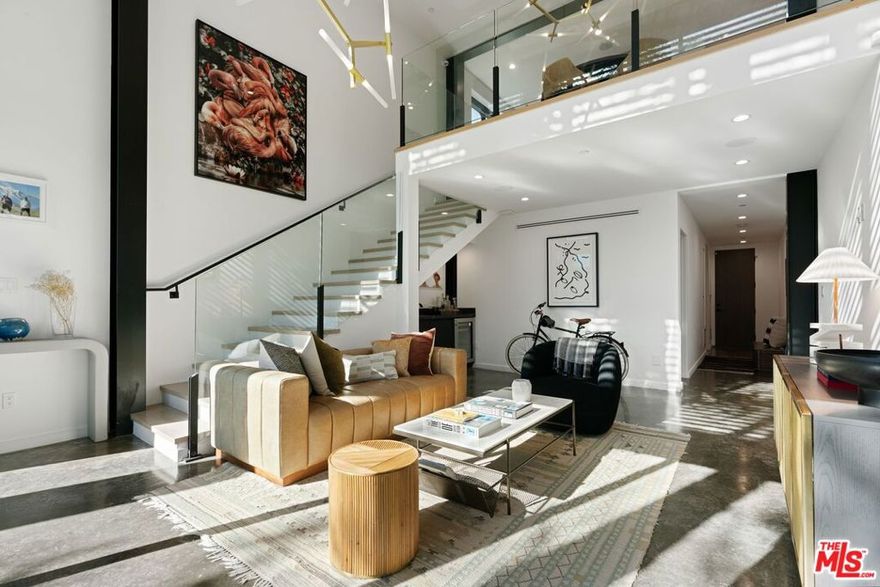 Tucked behind private gates in one of Venice's most coveted locations, this multi-level contemporary masterpiece defines modern luxury and sophistication. Blending cutting-edge smart home technology with striking architectural design, this 3-bedroom + office, 4-bath residence offers an elevated lifestyle with seamless convenience. Fully integrated with Control 4 smart home automation, enjoy effortless control of lighting, climate, security, entertainment, music, and motorized shades all at the touch of a button. Step through the oversized glass pivot door into a world of architectural drama. The entry is defined by 18-foot ceilings, polished concrete floors, oak accents, and exposed steelwork, creating a gallery-like aesthetic flooded with natural light from expansive walls of glass. The gourmet kitchen is a chef's dream, featuring top-of-the-line Miele, Viking, Wolf, and Sub-Zero appliances, custom cabinetry, and an oversized quartz peninsula ideal for both cooking and casual entertaining. Upstairs, the primary suite offers a serene retreat with sliding glass doors to a private balcony, a spa-inspired ensuite bathroom with soaking tub, and a walk-in closet. Two additional guest suites provide comfort and privacy for family or visitors. The showpiece of this home is the expansive rooftop deck, showcasing 360 views of the mountains and the Getty Museum. Designed for entertaining, the rooftop features custom awnings, a fire pit, outdoor speakers, and a built-in kitchen with refrigerator, sink, storage, concrete countertops, and a Kamado Big Joe III smoker the ultimate setting for sunset gatherings.  Health-focused upgrades throughout the home include a whole-house water filtration system, eco-friendly paint, professional HVAC and duct cleaning including all registers, and a high-end air purification and ionization system for enhanced indoor air quality. Additional highlights include a two-car garage plus an extra parking space and the option to purchase the home fully furnished for a turnkey experience. Perfectly situated just moments from Abbot Kinney's boutiques and restaurants, the new Hume Gym, The Lighthouse creative hub, and Windward Circle's vibrant dining and nightlife, 303 Venice Way places the best of Venice at your doorstep.