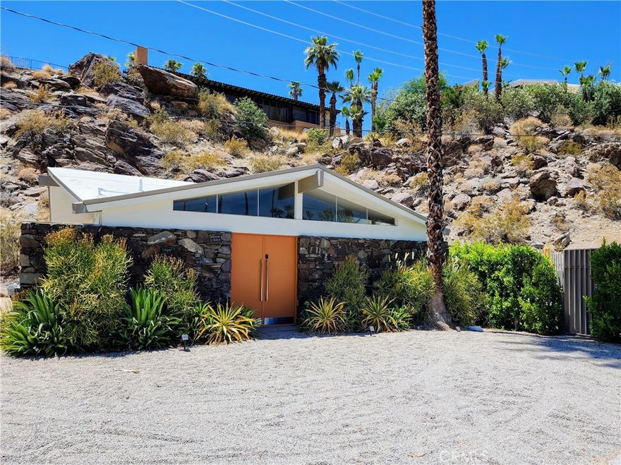 Property is leased till the end of September. Price will fluctuate in season. Weekly Rentals are Acceptable. Welcome to Your Dream Escape in Iconic Indian Canyons — the absolute coolest furnished rental homes in the posh Indian Canyons neighborhood of South Palm Springs.  Located at the base of the mountain with stunning mountain views, privacy, and unmatched character, this home sits on an expansive 18,000 square foot lot and is rumored to have once served as the clubhouse for Canyon View Estates. This Mid-Century architectural treasure features a magnificent 8-beamed umbrella ceiling and clerestory windows that flood the great room with natural light. The open and flexible floorplan offers ample space to relax or entertain. Step into the game room with a ping pong table and vibrant wall mural, or unwind in the beautiful living room with large picture windows that frame views of the sparkling swimming pool. The primary bedroom offers peaceful hillside views, a spacious walk-in closet, and an ensuite bathroom. The guest room enjoys access to a spa-style bath with a huge walk-in shower and an in-shower picture window overlooking the desert landscape. The updated kitchen and dining area feature peekaboo hillside views and open to a backyard oasis nestled against the hillside, complete with pool, spa, shaded gazebo, gas firepit, and lush palm tree scenery. Fully furnished and turnkey move-in ready, the beds are sooo comfortable, smart TVs with high-speed Wi-Fi, in house washer and dryer, kitchen fully stocked with pots and pans, dishes an air fryer and Keurig coffee maker. There is a workspace in the primary bedroom that can be moved to the kitchen for a communal workspace, solar blinds and black out curtains and lots of private parking. The property includes 32 solar panels and a 10kWh battery for major offset on electricity costs. Just minutes from downtown Palm Springs, the famous Murray Canyon Trail hike, and the exciting new Palm Springs Surf Club wave pool, this one-of-a-kind property is a true desert escape with unforgettable charm and lifestyle appeal. This beautiful furnished also offers a pull out sofa bed to sleep a total of 6 people. This long-term rental is available now through the end of the year. Traveling nurses welcome!