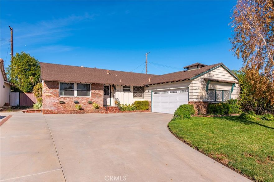 Welcome home to this inviting 4-bedroom, 3-bath Northridge residence offering 1,900 square feet of comfortable living space. The open layout features a spacious living room with wood-beamed ceilings, hardwood floors, and a charming brick fireplace. The kitchen offers ample cabinetry, tiled counters, and built-in appliances, flowing easily into the family and dining areas—ideal for gathering and entertaining. The primary suite includes a private bath and generous closet space, while secondary bedrooms are bright and welcoming. Outside, enjoy a large covered patio and sparkling pool—perfect for relaxing or hosting friends and family. With an attached two-car garage, central air and heat, and a great Northridge location near parks and schools, this home combines comfort, character, and everyday convenience.