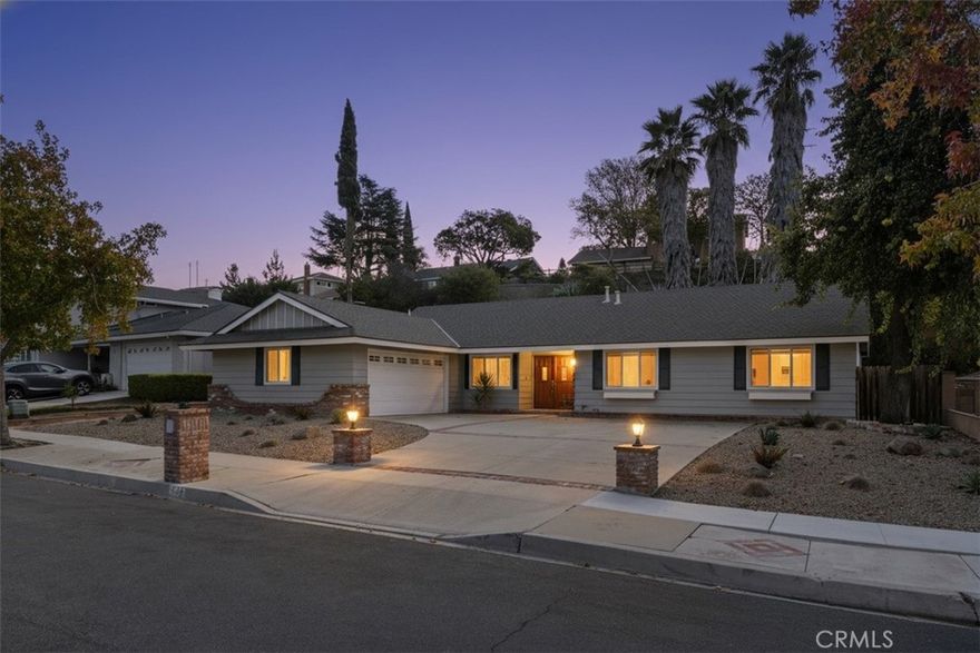 Rare opportunity — Lucero Street home in quiet, family-friendly neighborhood in one of the safest cities in the country, moments away from top-ranked schools.  Impressive curb appeal, with curved driveway and lighted pillars to accommodate multiple vehicles.  Three-bedroom, two-bathroom ranch home.  Open floor plan with family room and large living room.  Massive master bedroom with wall of his-and-her closets has enough space to create fourth bedroom (as in other models of this home). New porcelain kitchen counters and stainless steel appliances.  Working brick-front fireplace for the winter and central air for the summer. Two-car garage with storage closet. Low-maintenance front and back yards with hillside perfect for creating a terraced garden.  Thirty-foot palm trees in back.  Located just minutes from wonderful parks, Cal Lutheran University (with its huge public swimming pool), and great shopping.  Families keep their homes on Lucero Street for decades, so this is one you've been waiting for!