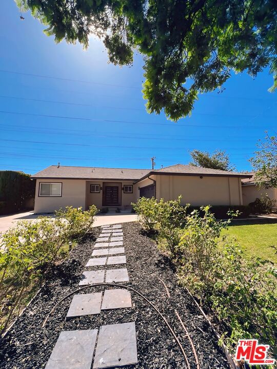 Move in before November 1st and enjoy the rest of October rent-free! **2 CAR GARAGE**WASHER/DRYER**CENTRAL A/C**LARGE BACKYARD**SUNROOM**MODERN LIVING** Welcome to this charming single-story house tucked away in one of Granada Hills' most serene pockets. The home beckons with a beautifully landscaped front yard and a walkway leading to an inviting entry. The property includes an attached 2-car garage and plenty of driveway & street parking. Step inside to discover bright natural light, newly refinished hardwood floors, high ceilings, laundry room, and a gas fireplace anchoring the living area. The open flow leads to a bright sunroom, perfect for a cozy reading nook, office, den, or casual dining space. The kitchen includes an eat-in breakfast nook and adjacent laundry/utility area with built-in storage. The home features three well-proportioned bedrooms and two fully remodeled baths with LED mirrors. The master suite offers its own private bathroom with a bidet! The residence includes modern amenities such as central heat/AC, dual-pane windows, and a fresh neutral palette throughout. Out back, the yard has been thoughtfully renovated into an entertainer's delight with ample patio, basketball court, lemon tree, lime tree, and spacious landscaping. Located minutes from freeways (405 / 118 access), top schools including John F. Kennedy High School and close to shopping, dining, and green space. This is a home that combines comfort, convenience, and character.