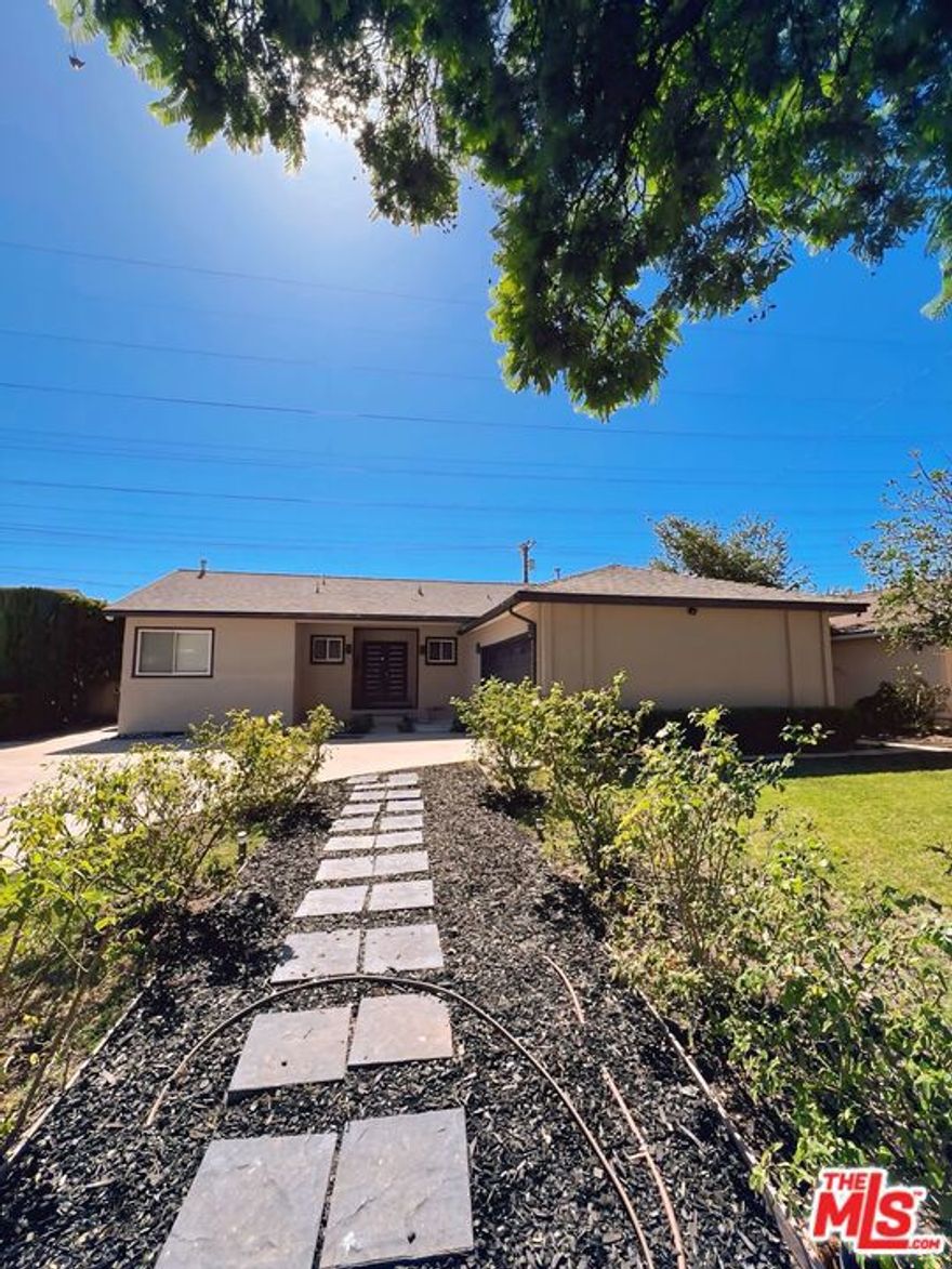 Move in before November 1st and enjoy the rest of October rent-free! **2 CAR GARAGE**WASHER/DRYER**CENTRAL A/C**LARGE BACKYARD**SUNROOM**MODERN LIVING** Welcome to this charming single-story house tucked away in one of Granada Hills' most serene pockets. The home beckons with a beautifully landscaped front yard and a walkway leading to an inviting entry. The property includes an attached 2-car garage and plenty of driveway & street parking. Step inside to discover bright natural light, newly refinished hardwood floors, high ceilings, laundry room, and a gas fireplace anchoring the living area. The open flow leads to a bright sunroom, perfect for a cozy reading nook, office, den, or casual dining space. The kitchen includes an eat-in breakfast nook and adjacent laundry/utility area with built-in storage. The home features three well-proportioned bedrooms and two fully remodeled baths with LED mirrors. The master suite offers its own private bathroom with a bidet! The residence includes modern amenities such as central heat/AC, dual-pane windows, and a fresh neutral palette throughout. Out back, the yard has been thoughtfully renovated into an entertainer's delight with ample patio, basketball court, lemon tree, lime tree, and spacious landscaping.  Located minutes from freeways (405 / 118 access), top schools including John F. Kennedy High School and close to shopping, dining, and green space. This is a home that combines comfort, convenience, and character.