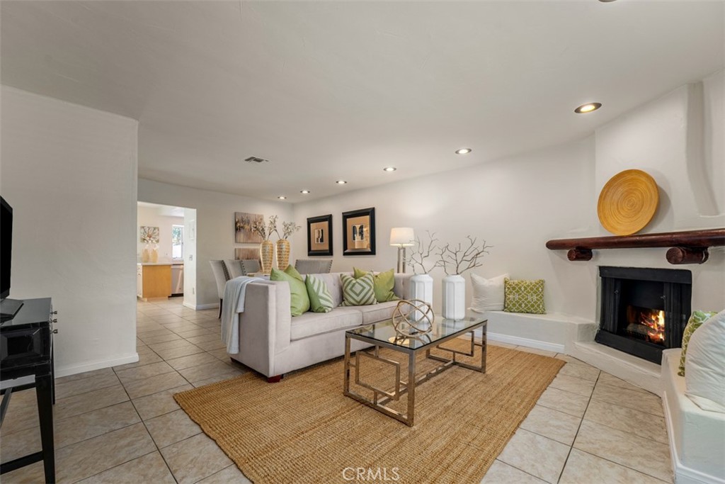 Welcome to Monarch Manor. A collection of only 42 condo units, tucked in the heart of the city. This charming condo features 2 spacious ensuite bedroom/bathroom ideal for privacy or hosting guests. Upon entry, the open living room sets the stage for casual seating, anchored by a fireplace. The living/dining area has a utility sink, counter space that can be dressed as a serving bar area as it transitions to the functional spaced kitchen. The kitchen feature new clean quartz countertops, brand new appliances and newer cabinetry with recessed lighting to brighten the space. Enjoy looking out to your private rear patio while prepping meals. A breakfast nook looks out through full sliding glass doors to your patio with concrete and mulched area. Step outside to your own private backyard patio, a perfect spot for morning coffee, relaxing evenings, or a small garden. A powder room on the main level offers convenience. Enjoy year-round comfort with central air conditioning and the ease of two assigned garage spaces, no more parking stress. The garage is attached to the building, but no direct access. Moving onto the second level and discover 2 bedrooms, with their own bathrooms. Generously-sized built-in closets completes the bedroom features. Both bathrooms are equally spacious. The community offers a fully fenced pool and lounging area. Monarch Manor is located in an area that feeds into the best schools, from Elementary to High school, that city of Fullerton offers, making it great for families or those planning ahead. It's ideal location with easy access to freeways, Brea Mall, major retail shops like Best Buy, Home Depot, Armstrong Garden, Aldi, CVS and so much more makes everyday living needs a breeze. Abundant guest parking and community laundry available on site. This home truly checks all the boxes for comfort, convenience, and location. Come see it for yourself—you’ll feel right at home!