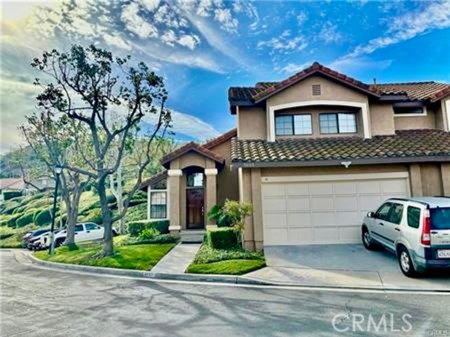 Beautiful 3-bedroom, 2.5-bath end-unit home with an attached 2-car garage and direct access. This spacious property features an open floor plan with soaring cathedral ceilings and wood and laminated flooring throughout the house (pics with carpet flooring taken prior to recent update). The family room opens to the kitchen and includes a cozy fireplace, perfect for relaxing or entertaining. The primary bedroom offers a second fireplace, adding warmth and charm. All three bedrooms are located upstairs. Enjoy a large private patio that opens to a peaceful greenbelt with mature trees, offering privacy and tranquility. Conveniently located next to guest parking and close to shopping centers, parks, schools, the library, and easy freeway access.