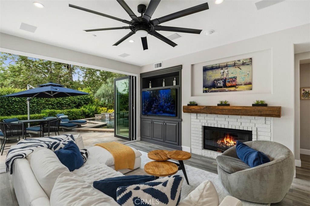 Nestled at the end of a peaceful cul-de-sac in the highly desired Courante tract of guard-gated
Coto de Caza, this home blends privacy and luxury with exceptional indoor-outdoor living.
Entertain effortlessly and relax comfortably in this resort-inspired retreat, featuring a saltwater
pool surrounded by a large wraparound yard and tranquil landscaping, all backed by trees and
serene wooded terrain. Approach through Coto’s tree-lined streets to your picturesque property
boasting impressive curb appeal and an attached tandem three-car garage. Enter inside to a
thoughtfully designed open floor plan, where abundant natural light streams through large
windows, filling every corner. The formal living room greets you with soaring ceilings, a fireplace,
and direct access to the private side patio. Nearby, a spacious formal dining room comfortably
hosts gatherings, complemented by stylish and practical porcelain tile wood-look flooring
throughout the main living areas. The remodeled gourmet kitchen showcases quartz
countertops, premium Mission-style cabinetry, and high-end appliances by Wolf and SubZero,
including a convection/steam oven and a built-in wine cooler. The large central island flows into
the adjoining family room, which hosts the home’s second fireplace. A versatile main-level
bedroom provides flexibility as a guest room, den, or private home office. Upstairs, retreat to
your expansive primary suite, boasting a private sitting area and Juliette balcony. The primary
bath provides a spa-like experience with heated floors, dual vanities, a large walk-in shower with
dual showerheads, and a spacious walk-in closet. Two additional upper-level bedroom suites
each offer full private baths, with the upstairs laundry area conveniently nearby. Outside, enjoy
your own private oasis, with manicured landscape and hardscape set around a stunning
saltwater pool, backing to waterfalls and lined with tall hedges. Additional upgrades include
solar electric with pre-paid lease until 2035, water filtration system, and Kuno security lighting.
Embrace the Coto de Caza lifestyle with amenities including horse trails, tennis, a clubhouse
with gym, pool, spa, BBQ areas, and two renowned championship golf courses designed by
Robert Trent Jones Jr. All just minutes away from diverse shopping and dining experiences. The
perfect combination of luxury, privacy, and community.