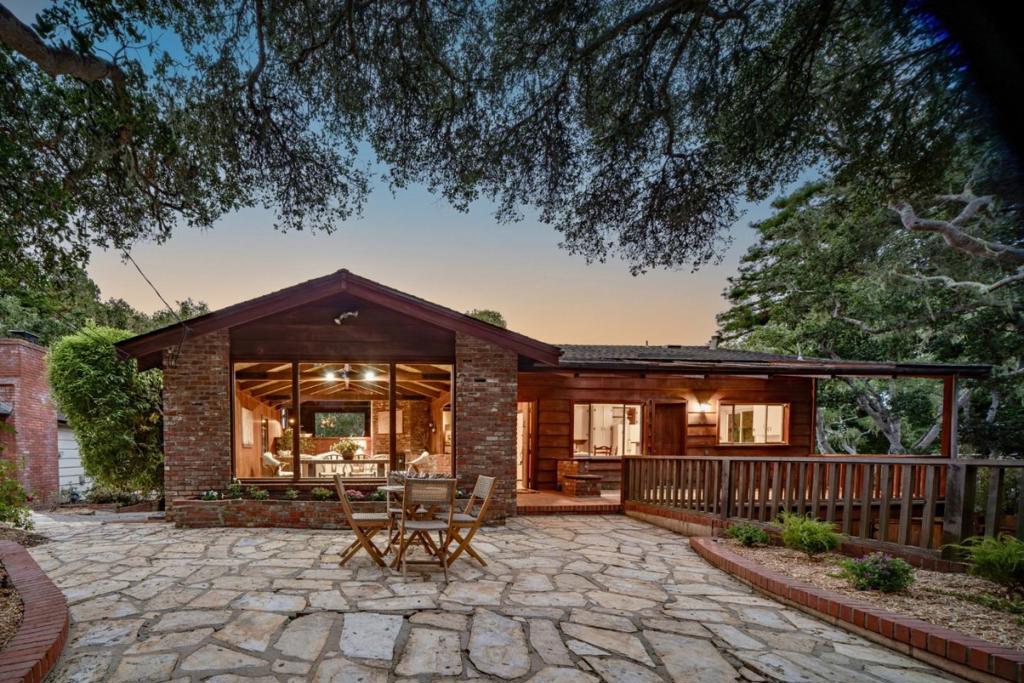 Welcome home to Cheerio Tipp--a legacy property in Carmel-by-the-Sea, offered for the first time in generations. This rare opportunity includes two homes on separate lots, totaling nearly 9700 sq ft, with individual parcel numbers and utilities. The larger Cheerio Tipp is rich in charm and lore. The family owned the first television in the neighborhood; friends and neighbors were always welcome to gather around and enjoy. On the main level, vaulted ceilings and old-growth redwood interiors create a warm, inviting atmosphere. Period details remain throughout--including a built-in pipe rack, a hidden safe, and cleverly concealed storage closets. A primary suite, spacious great room, eat-in kitchen, and loft with peeks of the Pacific complete this floor. Downstairs offers a full laundry room, guest suite, and two-car garage. Next door, "The Little House" sits on a 4000 sq ft lot and includes two bedrooms, one bath, a cozy living room with fireplace, and a generous deck. Both homes enjoy Carmel stone patios, garden space, and spots to sip morning coffee or dine al fresco. Just blocks from downtown shops, restaurants, galleries, and Carmel's white sand beaches, this is a rare chance to continue a cherished legacy and become the next custodian of an extraordinary double-lot property.