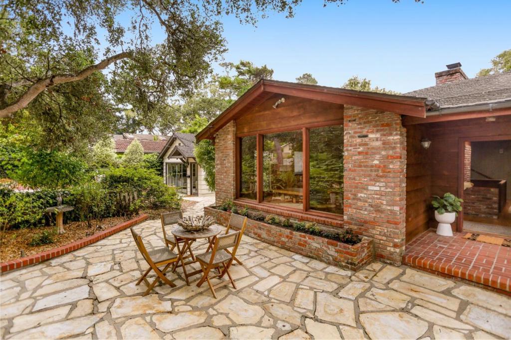 Welcome home to Cheerio Tipp and The Little House--a legacy property in Carmel-by-the-Sea, offered for the first time in generations. This rare opportunity includes two houses on separate lots, totaling 9,663 sq ft, with individual parcel numbers and utilities. The larger Cheerio Tipp is rich in charm and lore. The family owned the first television in the neighborhood; friends and neighbors often gathered around to enjoy. On the main level, vaulted ceilings and old-growth redwood interiors create a warm, inviting atmosphere. Period details remain throughout--including a built-in pipe rack, a hidden safe, and cleverly concealed storage closets. A primary suite, spacious great room, eat-in kitchen, and loft with peeks of the Pacific complete this floor. Downstairs offers a full laundry room, guest suite, and two-car garage. Next door, "The Little House" sits on a 4000 sq ft lot and includes two bedrooms, one bath, a cozy living room with fireplace, and a generous deck. Both homes enjoy Carmel stone patios, garden space, and spots to sip morning coffee or dine al fresco. Just blocks from downtown shops, restaurants, galleries, and Carmel's white sand beaches, this is a rare chance to continue a cherished legacy and become the next custodian of an extraordinary double-lot property.