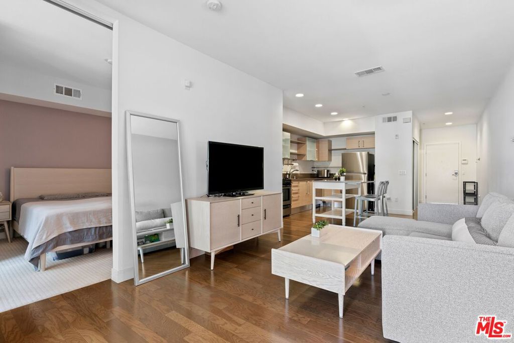 Modern Comfort in the Heart of Downtown LA Vero Living at Its Finest. Welcome to Unit #433 at the coveted Vero community a sleek and stylish 1-bedroom, 1-bathroom condo offering 700 square feet of contemporary living in one of Los Angeles' most vibrant urban neighborhoods. Thoughtfully designed with clean lines and natural light, this unit features an open-concept layout complemented by rich hardwood floors, high ceilings, and expansive windows that invite warmth and brightness throughout the space. The modern kitchen boasts European-style cabinetry, stainless steel appliances, and ample quartz counter space perfect for cooking or entertaining. The spacious living and dining area flows seamlessly into a private balcony, creating an ideal indoor-outdoor lifestyle. The bedroom offers a peaceful retreat with a custom closet and a bathroom adorned with sleek finishes. Additional highlights include central air conditioning for year-round comfort and an in-unit washer and dryer for everyday convenience. Enjoy two assigned gated parking spaces and access to Vero's top-tier amenities, including a resort-style heated pool and spa, 24-hour fitness center, dry sauna, yoga/dance studio, business center/library, barbecue areas, concierge service, and 24-hour security. Water and trash are included in the HOA dues. Ideally located on Wilshire Blvd, Vero offers quick access to LA Live, Crypto.com Arena, Koreatown, the Financial District, and a world of shopping, dining, and entertainment options. Whether you're seeking your first home or an investment opportunity, Unit #433 blends luxury, comfort, and convenience in the heart of the city. Fannie Mae Approved Building.