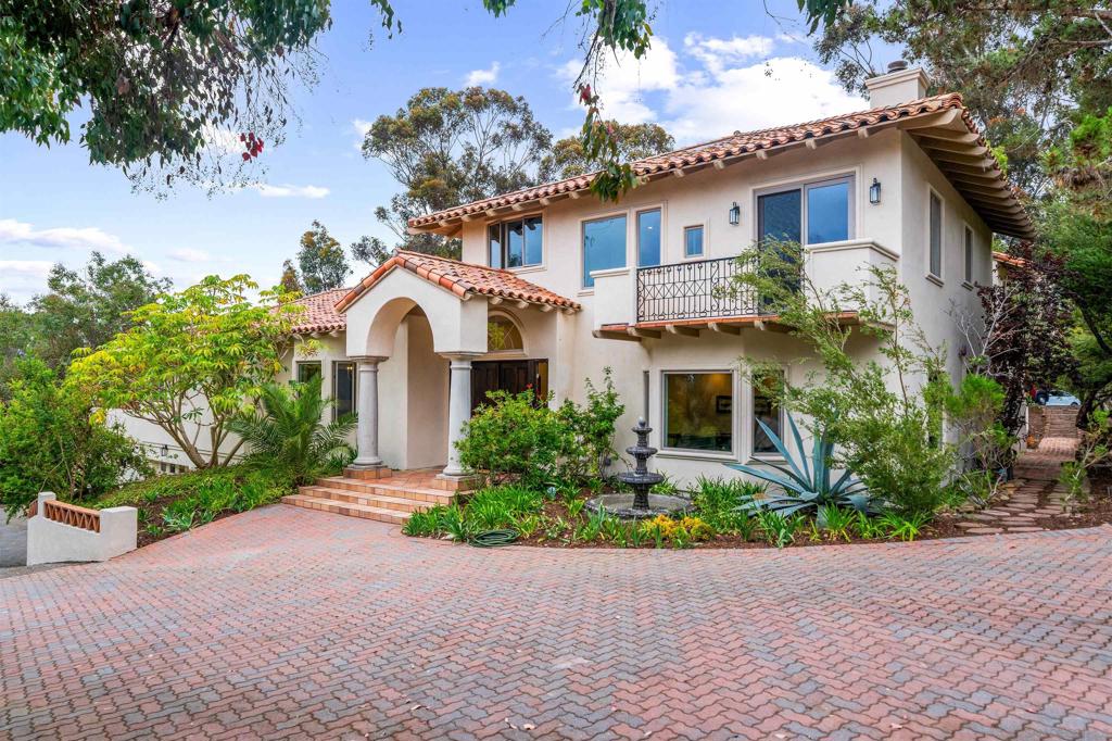 Nestled within beautiful Rancho Santa Fe, this exquisite Spanish style estate offers timeless elegance and exceptional privacy on 1.32 beautifully landscaped acres. Surrounded by mature trees and featuring a tranquil pond, this home is designed for both grand entertaining and an everyday retreat. Originally built in 1976, the home has been thoughtfully expanded and remodeled over the years, showcasing a harmonious blend of classic craftsmanship and luxury. Inside, you'll find expansive living spaces filled with natural light, dramatic wood beam ceilings, and handcrafted Spanish tile accents that lend unique charm throughout. The chef’s kitchen is an entertainer’s dream, highlighted by rare Blue Bahia granite countertops and ample space for gathering. Designed with flexibility in mind, the home includes two luxurious upstairs primary suite - both with oversized bathtubs, including one with a jetted tub - as well as five additional rooms that can be tailored to your lifestyle as bedrooms, offices, playrooms, or creative spaces. Step outside to an oversized saltillo tiled patio perfect for hosting gatherings, and enjoy the added bonus of a 600+ sq. ft. detached space perfect as an office, private studio, workshop with a half bath, or easily convert into an ADU - offering a versatile haven for productivity, creativity, or relaxation. Indulge in exceptional amenities, from your own private sauna and an expansive nine-car garage to beautifully appointed fireplaces in the primary bedroom, family room, and reading room each space designed for comfort and sophistication. This one-of-a-kind residence is on the market for the first time in over 30 years - an opportunity not to be missed. With no HOA fees and an unbeatable location just a short walk from the prestigious Diegueño Country School (K–6) and the five star Rancho Valencia Resort, this home offers luxury living in one of Southern California’s most sought-after communities. This home is a true hidden gem with undeniable character and an absolute must see! Please enjoy a selection of artist renderings included with the photography in the 2nd primary suite and optional rooms thoughtfully designed to help you visualize the beauty of each room.