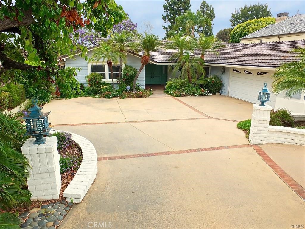 Experience timeless California living in this rare single-level mid-century modern estate designed by the acclaimed firm Powers, Daly & DeRosa. Nestled on nearly half an acre in the heart of prestigious Park Estates, this residence offers approximately 3,700 sq. ft. of beautifully remodeled living space—perfect for entertaining, relaxing, and enjoying the Southern California lifestyle.
Inside, dramatic vaulted wood ceilings, an iconic dual-sided brick fireplace, and expansive walls of glass create an airy, sun-filled atmosphere that blends indoor comfort with seamless outdoor connection. The modernized kitchen and updated bathrooms bring contemporary style to this architectural classic.
The open floor plan offers elegant spaces for gatherings, including a formal living room, fireside dining area, den/family room, and cozy sitting areas. The primary suite feels like a private retreat with rows of closets, a vanity area, and an adjacent office or lounge overlooking the lush gardens.
Step outside to a large elevated patio, perfect for family get-togethers or peaceful mornings with coffee. The home also features a curved driveway, 2-car attached garage, central heating and air, automatic sprinklers, and a newer concrete tile roof for comfort and convenience.
Located in one of Long Beach’s most sought-after neighborhoods, this home offers the ideal balance of privacy, space, and community—a perfect place to raise a family or simply enjoy the charm and serenity of Park Estates living.