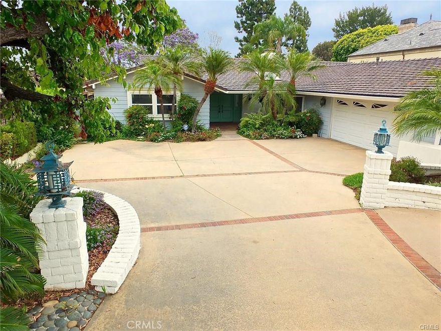 Experience timeless California living in this rare single-level mid-century modern estate designed by the acclaimed firm Powers, Daly & DeRosa. Nestled on nearly half an acre in the heart of prestigious Park Estates, this residence offers approximately 3,700 sq. ft. of beautifully remodeled living space—perfect for entertaining, relaxing, and enjoying the Southern California lifestyle.



Inside, dramatic vaulted wood ceilings, an iconic dual-sided brick fireplace, and expansive walls of glass create an airy, sun-filled atmosphere that blends indoor comfort with seamless outdoor connection. The modernized kitchen and updated bathrooms bring contemporary style to this architectural classic.



The open floor plan offers elegant spaces for gatherings, including a formal living room, fireside dining area, den/family room, and cozy sitting areas. The primary suite feels like a private retreat with rows of closets, a vanity area, and an adjacent office or lounge overlooking the lush gardens.



Step outside to a large elevated patio, perfect for family get-togethers or peaceful mornings with coffee. The home also features a curved driveway, 2-car attached garage, central heating and air, automatic sprinklers, and a newer concrete tile roof for comfort and convenience.



Located in one of Long Beach’s most sought-after neighborhoods, this home offers the ideal balance of privacy, space, and community—a perfect place to raise a family or simply enjoy the charm and serenity of Park Estates living.