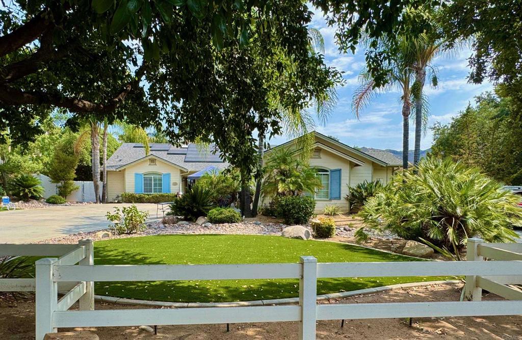 Welcome to 24608 Watt Road—a beautifully upgraded single-story retreat on over half an acre in Ramona! This 4-bedroom, 3-bath home offers 2,364 sq ft of inviting living space, surrounded by meticulously landscaped grounds. Step outside and discover your own private resort: an impressive outdoor kitchen cabana featuring a built-in grill, Traeger smoker, mini fridge, TV, and bar—perfect for entertaining family and friends year-round. The property is irrigated by both public water and a private well that keeps your landscaping lush while helping reduce your monthly water bills. Enjoy comfort and energy savings with 23 leased solar panels, providing predictable electricity costs of $276/month, so you can run the air conditioning as much as you like without surprises. Major systems have been thoughtfully updated: the roof, HVAC, and furnace are all approximately 5 years old, offering peace of mind for years to come. Additional highlights include an automatic electric gate along the side of the house with generous RV access and parking, plus a detached 2-car workshop—ideal for hobbies, storage, or extra vehicles. Don’t miss this rare combination of indoor comfort, outdoor living, and energy efficiency in one of Ramona’s most desirable locations.