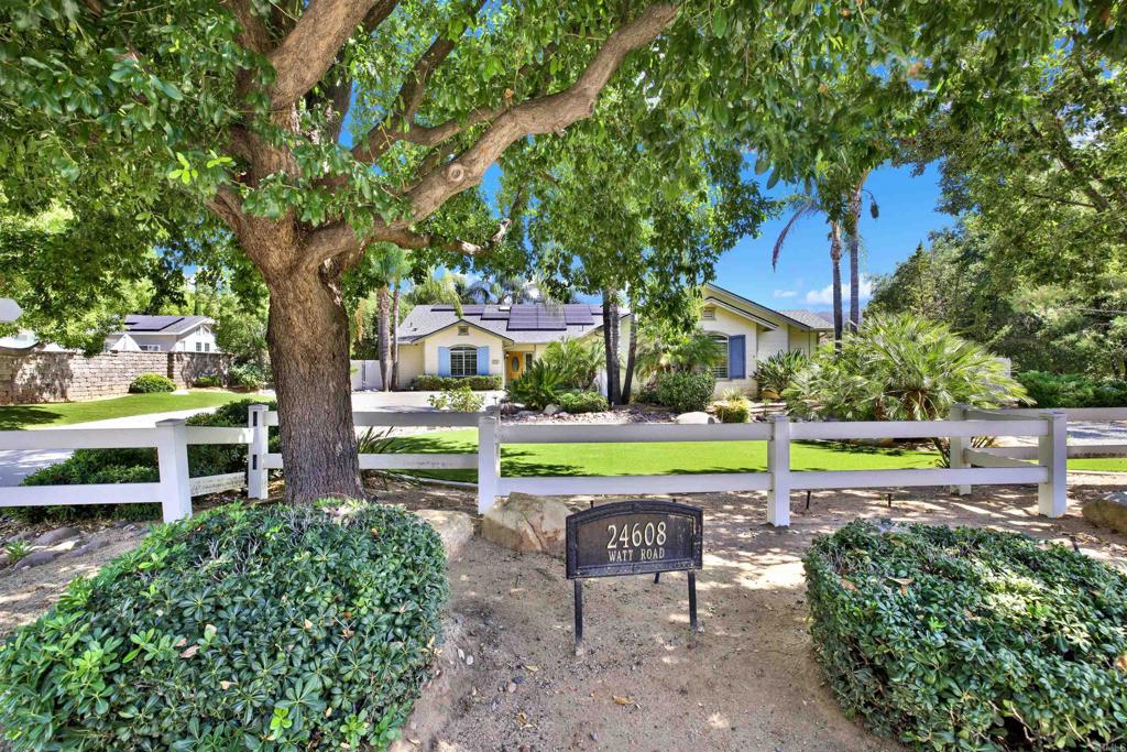 Welcome to 24608 Watt Road—a beautifully upgraded single-story retreat on over half an acre in Ramona! This 4-bedroom, 3-bath home offers 2,364 sq ft of inviting living space, surrounded by meticulously landscaped grounds. Step outside and discover your own private resort: an impressive outdoor kitchen cabana featuring a built-in grill, Traeger smoker, mini fridge, TV, and bar—perfect for entertaining family and friends year-round. The property is irrigated by both public water and a private well that keeps your landscaping lush while helping reduce your monthly water bills. Enjoy comfort and energy savings with 23 leased solar panels, providing predictable electricity costs of $276/month, so you can run the air conditioning as much as you like without surprises. Major systems have been thoughtfully updated: the roof, HVAC, and furnace are all approximately 5 years old, offering peace of mind for years to come. Additional highlights include an automatic electric gate along the side of the house with generous RV access and parking, plus a detached 2-car workshop—ideal for hobbies, storage, or extra vehicles. Don’t miss this rare combination of indoor comfort, outdoor living, and energy efficiency in one of Ramona’s most desirable locations.