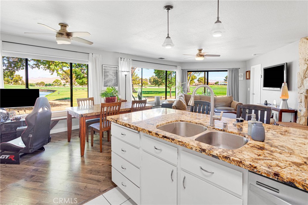 New price!! You’re in luck! The condo with the BEST view in Silver Lakes is now available. This resort community includes an abundance of amenities. This particular unit is an end unit with an unobstructed view of the pond, the golf course and mature shade trees. It also enjoys the serenity of the sound of the water feature. The covered patio overlooks this impressive and serene setting. The interior is designed to bring the impressive view indoors with large windows outfitted with custom remote operated cellular shades. The view is panoramic. This home’s upgraded interior includes vinyl wood-look flooring, granite counters, upgraded lighting and fixtures. Stone hearth fireplace in the living room. Large dining area perfect for entertaining. Open floor plan accommodates a large sofa suite. Split floor plan for the enjoyment of privacy. The primary bedroom suite overlooks the green landscape and water as well. Indoor laundry with storage in a separate room. This home is built for every day enjoyment, or as a peaceful vacation destination. Want golf? Swimming? Parks? Fishing? Well, Silver Lakes HOA and the Fairway Court condo association offer all of that included! The finished garage includes a workshop/hobby area, walk-up attic access; space for your golf carts bikes, water toys, and more. This home is ready to go as a vacation getaway with great proximity to Los Angeles, and the Ontario International Airport. Silver Lakes in Helendale, CA is an oasis. The picturesque, well-maintained master planned community offers a lifestyle where you can vacation where you live. Come see what awaits in this gem of a setting. This is a rare find with a breathtaking setting. Seller will review all reasonable offers. Don’t be shy come take a look at this home today!