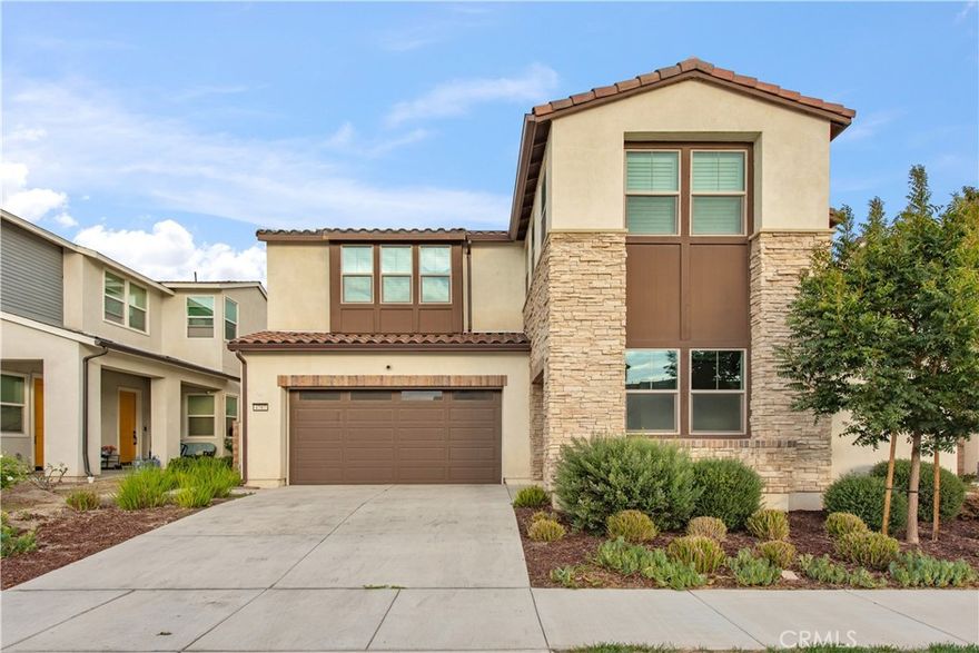 this property boasts a multitude of upgraded features that will exceed your expectations. As you step inside, you'll be greeted by the elegance of luxury vinyl flooring and the warm ambiance of recessed lighting throughout the home. The heart of this home is the gourmet kitchen, showcasing quartz countertops, upgraded appliances, extended kitchen cabinets, and a convenient walk-in pantry. Adjacent to the kitchen, you'll find a charming California sunroom patio, perfect for outdoor dining and relaxation. Downstairs, a private en-suite bedroom provides comfort and convenience for guests or multigenerational living. Your peace of mind is ensured with the upgraded security system, complete with 4 exterior cameras, sensor-equipped windows and doors, and interior home motion sensors. Luxury vinyl and tile flooring gracefully extend throughout the home, offering both durability and aesthetics. The master suite is an absolute retreat, featuring a massive 12ft x 13ft walk-in closet and a spa-like bathroom with a generously sized shower. Each of the remaining bedrooms also boasts walk-in closets, ensuring ample storage space for your family's needs. This home offers abundant cabinet storage throughout, making organization a breeze. . This is the largest floor plan available in Ontario Ranch and includes a 3-car garage, providing plenty of space for your vehicles and storage needs.