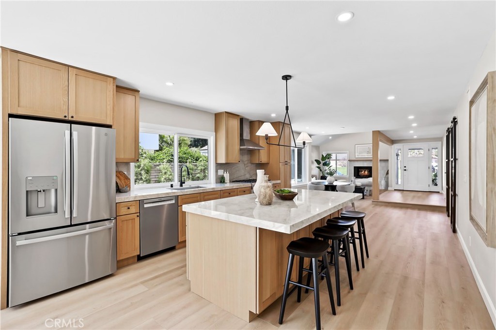 Step into this beautifully updated home where modern design meets everyday comfort. Featuring 3 spacious bedrooms plus a dedicated home office overlooking a private interior courtyard, the open-concept layout is perfect for both daily living and entertaining. Luxury vinyl plank flooring runs throughout, paired with white oak shaker cabinets, designer hardware, and Taj Mahal quartz countertops with a full-height backsplash in the kitchen.
Enjoy high-end Bosch stainless steel appliances, upgraded lighting fixtures, and striking white oak-wrapped beams at the entryway. The primary suite is a true retreat with vaulted ceilings, skylights, and ample natural light. Both bathrooms have been fully remodeled with new tile, custom vanities, quartz counters, and contemporary plumbing fixtures.
Other highlights include new PEX piping, energy-efficient dual-paned windows and sliding doors, and LED lighting throughout. Outside, a generously sized backyard offers plenty of space for relaxing or entertaining. Located in a desirable community with access to a pool, spa, tennis and pickleball courts, and served by award-winning schools.