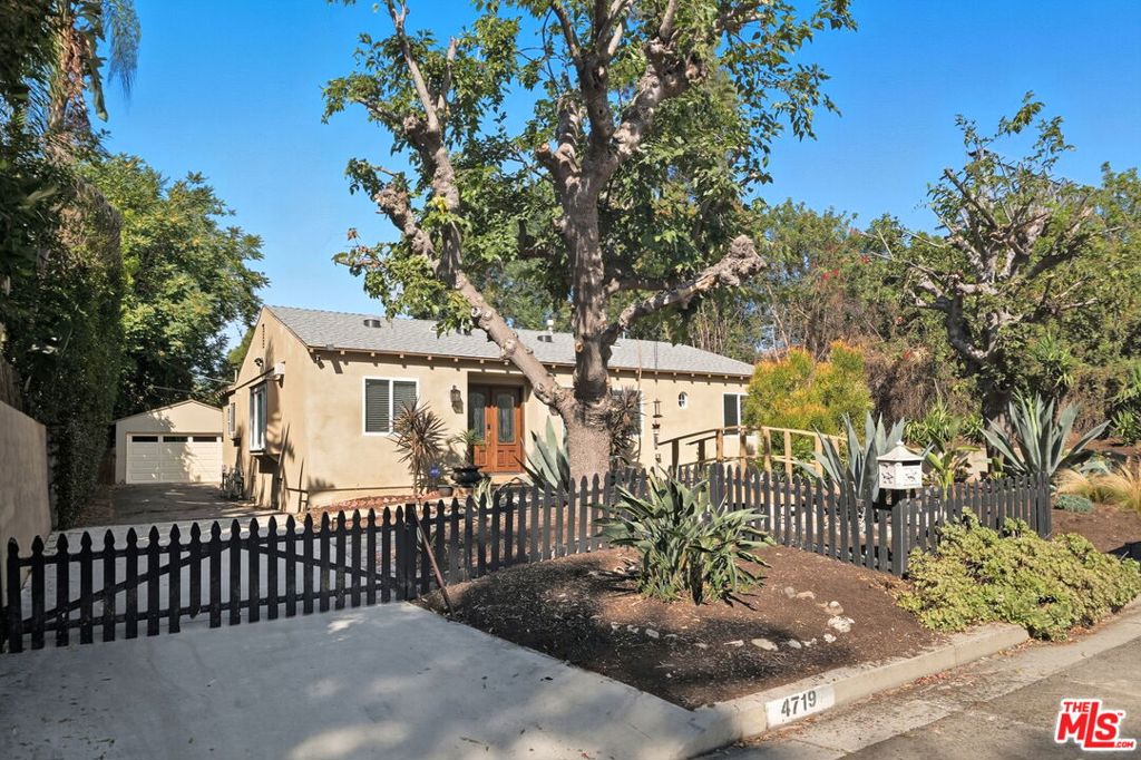***A Storybook Retreat in Coveted Sherman Oaks*** Tucked away at the end of a tranquil cul-de-sac in the desirable M-Street neighborhood, this beautifully updated 3-bedroom, 3-bath home offers the perfect balance of modern convenience and timeless charm. With 2,029 sq. ft. of living space on an expansive 8,780 sq. ft. lot, this residence is designed for both effortless everyday living and unforgettable entertaining. Step inside to freshly painted interiors filled with natural light, where the open kitchen showcases white shaker cabinets with modern chrome finishes, porcelain tile flooring, and newer Samsung appliances. Thoughtful upgrades include a new EV-ready charger outlet, paid-off solar panels, a tankless water heater, and a smart-operated sprinkler system for sustainable, low-maintenance living. The owner's suite is a true sanctuary with soaring ceilings, dual walk-in closets, recessed lighting, and French doors that open directly to the backyard. The spa-inspired ensuite bath features a new chic double vanity and a double shower with a waterfall showerhead. Outdoors, the lush, private setting feels like your own park, complete with a sparkling pool, a shaded pergola patio perfect for al fresco dining, a peaceful pond, and easy-care turf ideal for kids and pets. A 2-car detached garage plus a long driveway provides ample parking. The storybook front yard, with its charming bridge over a brook beneath mature trees, sets a welcoming tone from the very first glance. Located in one of Sherman Oaks' most sought-after neighborhoods, this home offers convenient access to vibrant dining, shopping, and freeway connections while still providing a quiet, retreat-like atmosphere.