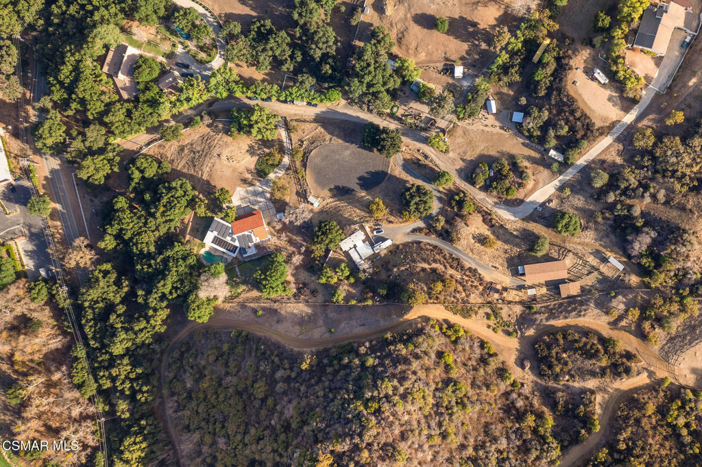 A Rare Equestrian Retreat Just Minutes from Westlake Village. A rural setting nestled just off E Carlisle Road, in the serene and picturesque Santa Monica Mountains, this remarkable estate offers a peaceful retreat. Combining privacy and tranquility, this horse property spans two parcels and 4.4 acres, making it a true haven for equestrian enthusiasts.The main residence is a charming ranch-style home featuring exposed wood beams that lend warmth and character throughout. With 3 bedrooms and 3 bathrooms, the home boasts a spacious living room, office, and a large kitchen and dining area ideal for gatherings. The cozy family room, complete with a charming fireplace, offers a welcoming retreat. Additionally, the home includes a 3-car garage for ample parking and storage.The equestrian facilities are equally impressive, with a custom 3-stall barn, tack room, 3 outdoor corrals, and a professionally designed riding arena complete with specialty footing for optimum performance. Extensive trail systems are just a short trailer ride away making this property a perfect haven for horse lovers and anyone who appreciates an equestrian lifestyle.Whether you're seeking a peaceful retreat or a fully equipped equestrian property, this home offers an unparalleled opportunity to own this one-of-a-kind gem that combines luxury living with a true passion for horses.Includes (2) APN Numbers- APN #695-0-230-345 (2.46 acres) & APN #695-0-230-335 (1.94 acres)Additional Adjacent Land Available For Sale (MLS #25000409), 12.95 Acres To Create A Possible 17.35 Acre Property.