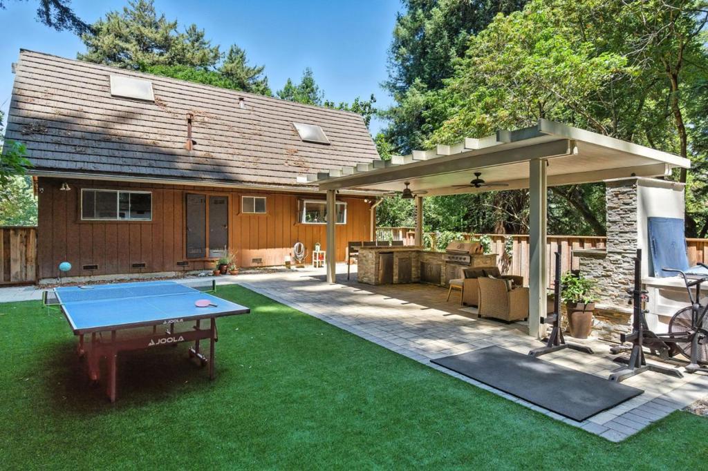 Very cool A-frame style home located in the Chemeketa Park community just minutes from Downtown Los Gatos. Set on a private lot this 3-bedroom home offers a peaceful retreat close to town and great schools like Lexington Elementary and Los Gatos High. Inside you are greeted with soaring vaulted ceilings and large windows that bring in natural light and views of the trees. The open concept living and kitchen areas feature a wood-burning fireplace, quartz countertops, freshly painted cabinets, and stainless appliances. There are two bedrooms and a full bath on the main level, with a third bedroom and second bath upstairs. The backyard is Amazing and has a covered outdoor kitchen with BBQ, granite counters, dining bar, mini fridge and a built-in gas fireplace for year-round use. There is also room to play on the low-maintenance turf lawn area. Plenty of parking in the driveway for multiple vehicles. Chemeketa Park is a friendly neighborhood with a community clubhouse, playground, and garden.