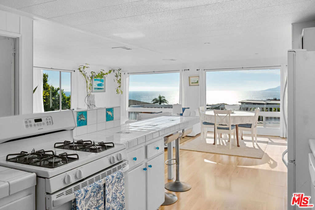 Location, Location, Location! Tucked away on a peaceful cul-de-sac in the highly sought-after Point Dume Club, this charming ocean-view home is a rare gem. Offering approximately 1680 sq. ft. of living space, this 2-bedroom, 2-bathroom home, plus 2 additional rooms perfect for a home office, guest room, or creative studio. Enjoy breathtaking whitewater ocean and mountain views from the light-filled kitchen, living and dining areas, plus an expansive deck ideal for outdoor entertaining or peaceful sunset evenings. The spacious primary bedroom features a walk-in closet and double sink vanity. One of the additional rooms features ocean & mountain views with sliding door out to deck. Laundry area for your convenience, 3 car covered parking, front patio entry, plus a side yard. This home is situated on a large lot, in a quiet cul-de-sac, near guest parking and small green belt area. Whether you're looking for a weekend escape or full-time coastal living, this special property offers endless potential to expand or renovate to suit your vision. Make it your own and experience the best of Malibu beachside living! Great location, and a lower space rent makes this an incredible buy for a primary residence, second home, or investment property. The highly desirable Point Dume Club community offers extensive amenities, including a year round heated pool, clubhouse, spa, sauna, tennis and basketball court, playground, dog run, and more. With 24-hour security, the community prioritizes safety and peace of mind. Just a short walk, bike or golf cart away from local schools, the Point Dume shopping center, and Zuma Beach. Embrace the Malibu lifestyle today. Call or Text me for a private showing.