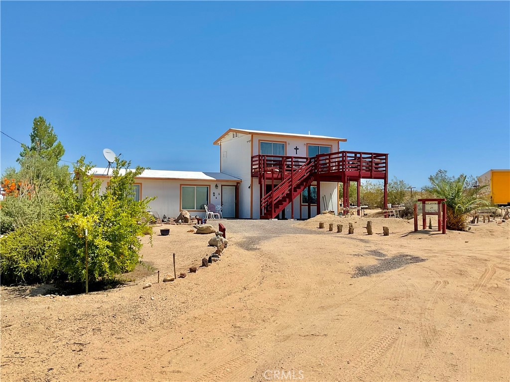Nestled on 5 expansive acres of natural beauty, this charming 3-bedroom, 2-bath, two-story home offers the perfect blend of privacy, tranquility, and potential. Surrounded by breathtaking scenery, and fruit trees, it's the ideal escape for those seeking peace and quiet or a creative retreat. This home features a spacious layout with all the essentials, ready for your personal touch and vision. Upstairs bedrooms offer beautiful views of the serene landscape, while the main living areas provide a warm and inviting space to relax or entertain. A bonus to this peaceful haven is the small detached studio-perfect as an artist's space, home office. Whether you are dreaming of a desert getaway, a full-time residence, or an investment with potential, this property offers endless possibilities! Fully fenced with a solar powered gate! Gaze at the starry nights while sitting on your balcony and breathe in the fresh air. So Peaceful and tranquil, you do not want to miss out on this beauty. Come view this home today!!