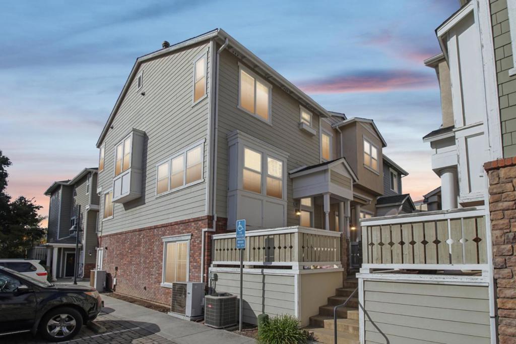 Beautiful east-facing craftsman-style end-unit townhome in a prime Cupertino location with top-rated Cupertino schools! Built in 2010, this 1,762 SqFt home offers 4 bedrooms and 2.5 baths with an inviting open floor plan. The elegant living room features soaring ceilings, picture windows, gleaming wood floors, and decorative tile stairs. The open family/dining area provides the perfect space for entertaining and relaxation. The gourmet kitchen includes granite countertops, stainless steel appliances, abundant cabinetry, recessed lighting, and a cozy dining area. A main-level half bath is ideal for guests, and the lower-level bedroom is perfect for multi-generational living. Upstairs features a spacious primary suite with dual sinks and large shower, plus two additional bedrooms and a full bath. Finished 2-car garage, new interior paint, updated lighting fixtures, and convenient access to Apple Park, Main Street Cupertino, and parks!