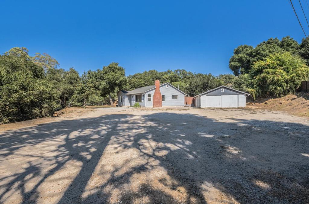 Situated on nearly 2.9 acres in the peaceful Mallory Canyon area, this property features a charming 3-bedroom, 1-bath main home with rustic touches including exposed beam vaulted ceilings, a wood-burning brick fireplace, and a kitchen with granite countertops. The spacious back deck is perfect for outdoor living, while the detached garage has been converted into an additional 3-bedroom, 1-bath living space, ideal for extended family, guests, or rental opportunities. With gently rolling land offering room for hobby farming, horses, or simply enjoying the tranquility of country living, this property combines privacy and versatility, all just minutes from Hwy 101 for easy access to town.